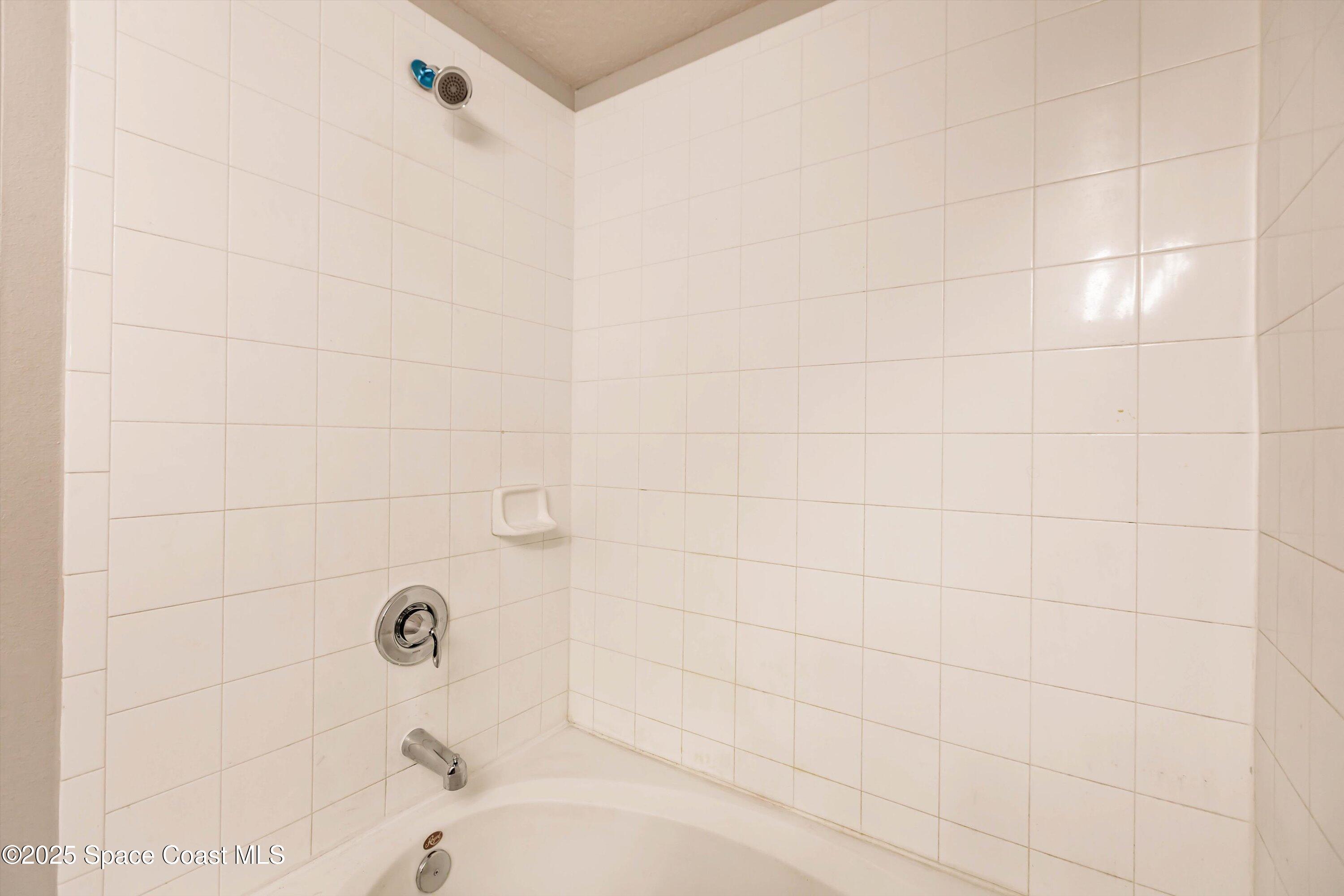 3061 Tazewell Avenue Southeast Palm Bay, FL 32909 - Photo 19 of 30 a bathroom with a bathtub