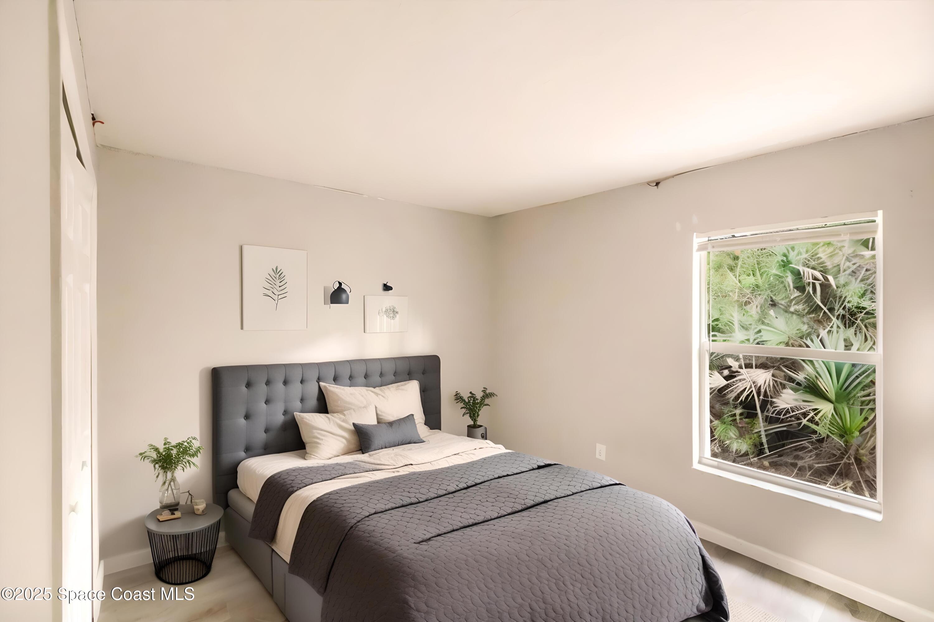 3061 Tazewell Avenue Southeast Palm Bay, FL 32909 - Photo 21 of 30 a bedroom with a bed and a window