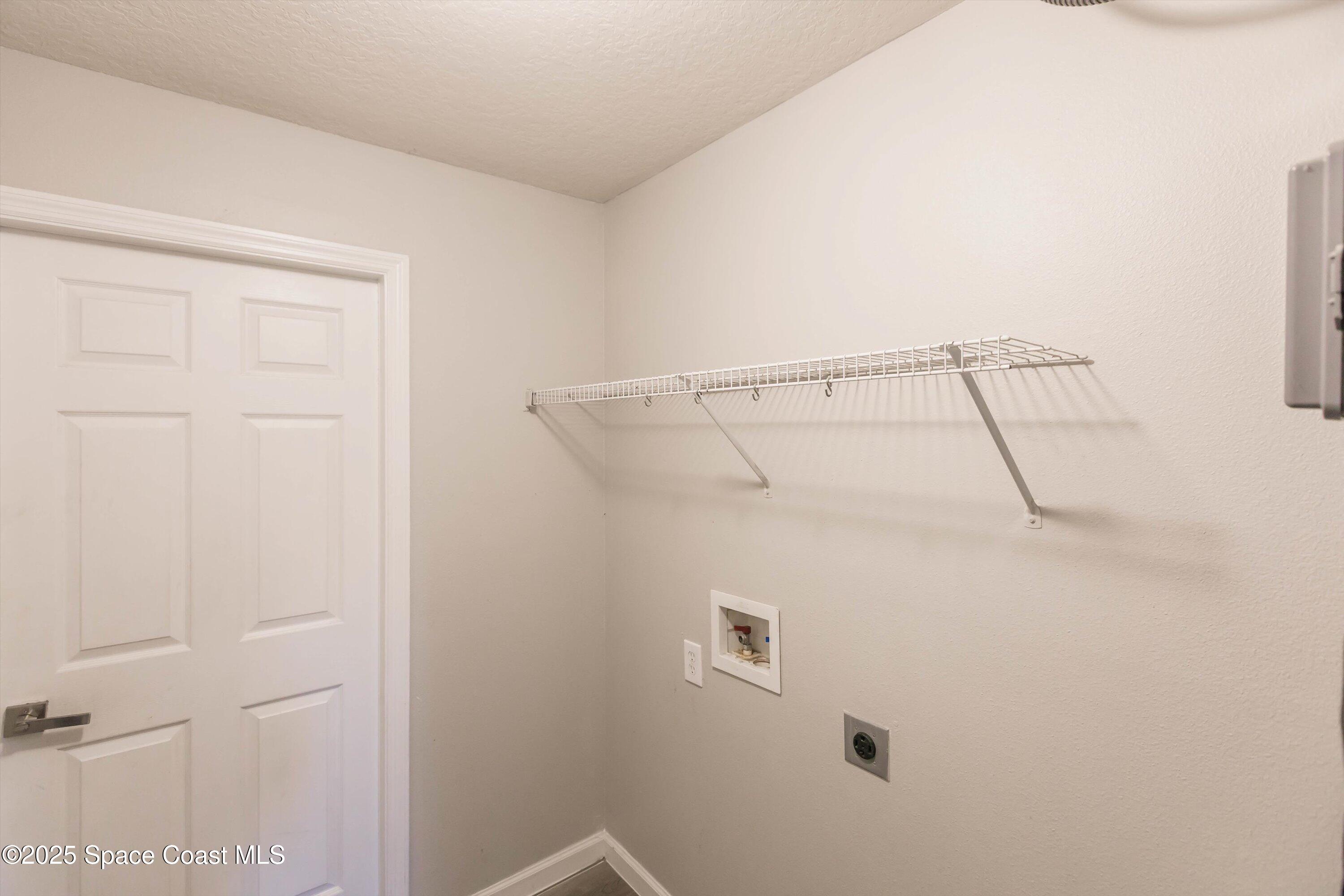 3061 Tazewell Avenue Southeast Palm Bay, FL 32909 - Photo 23 of 30 a bathroom with a glass shower door