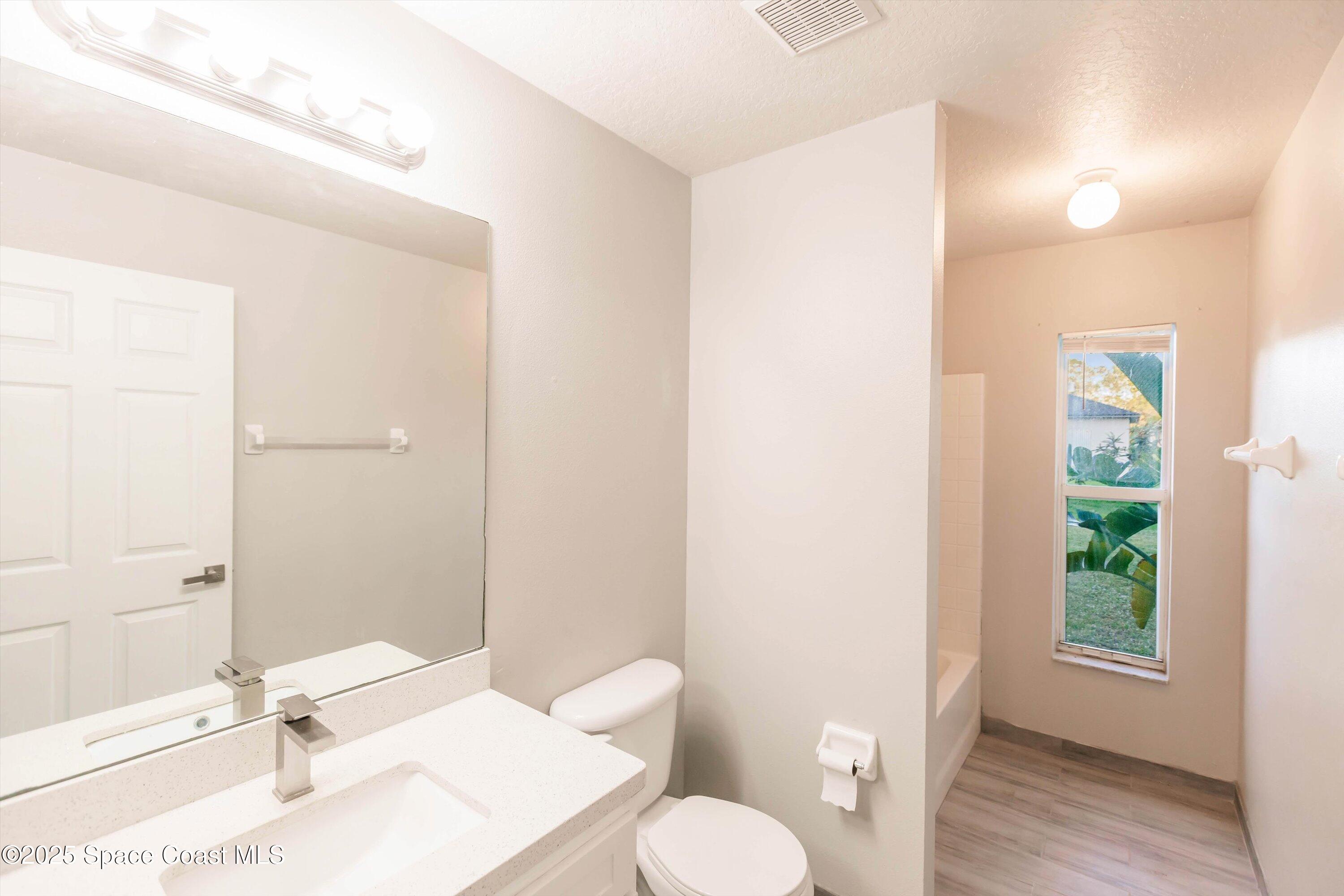 3061 Tazewell Avenue Southeast Palm Bay, FL 32909 - Photo 25 of 30 a bathroom with a sink toilet and shower