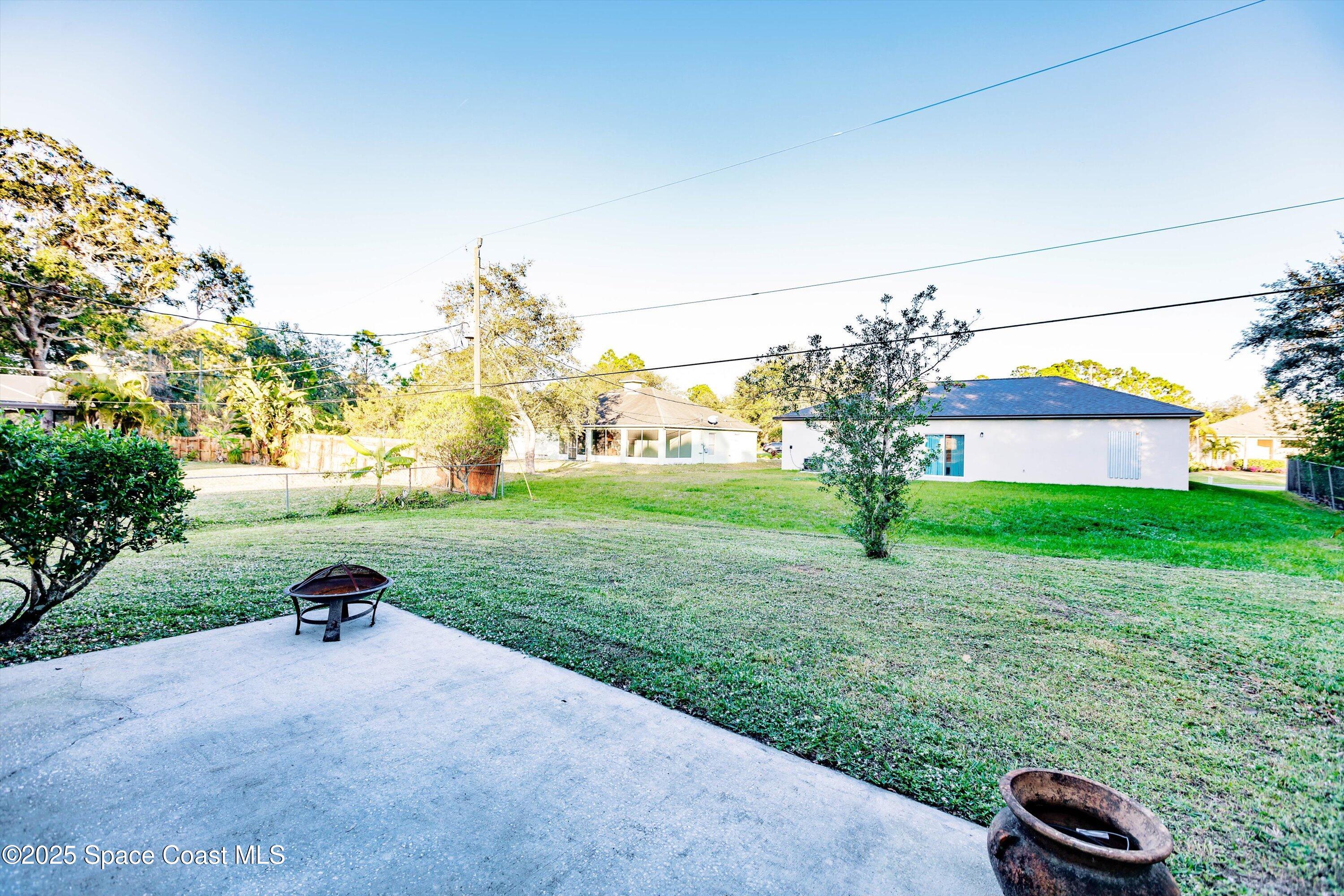 3061 Tazewell Avenue Southeast Palm Bay, FL 32909 - Photo 29 of 30 a view of a backyard with garden and trees