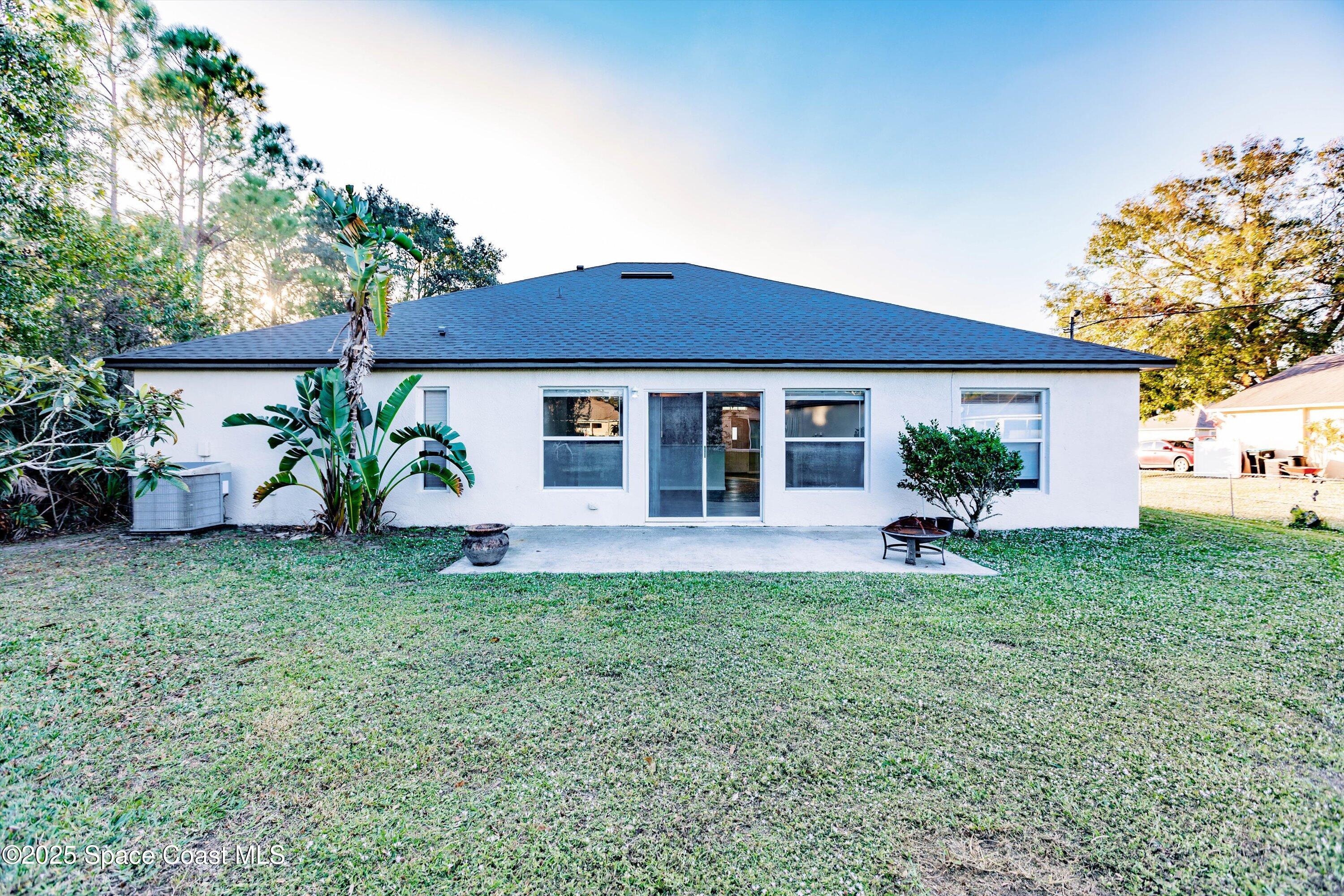 3061 Tazewell Avenue Southeast Palm Bay, FL 32909 - Photo 30 of 30 a front view of a house with table and chairs