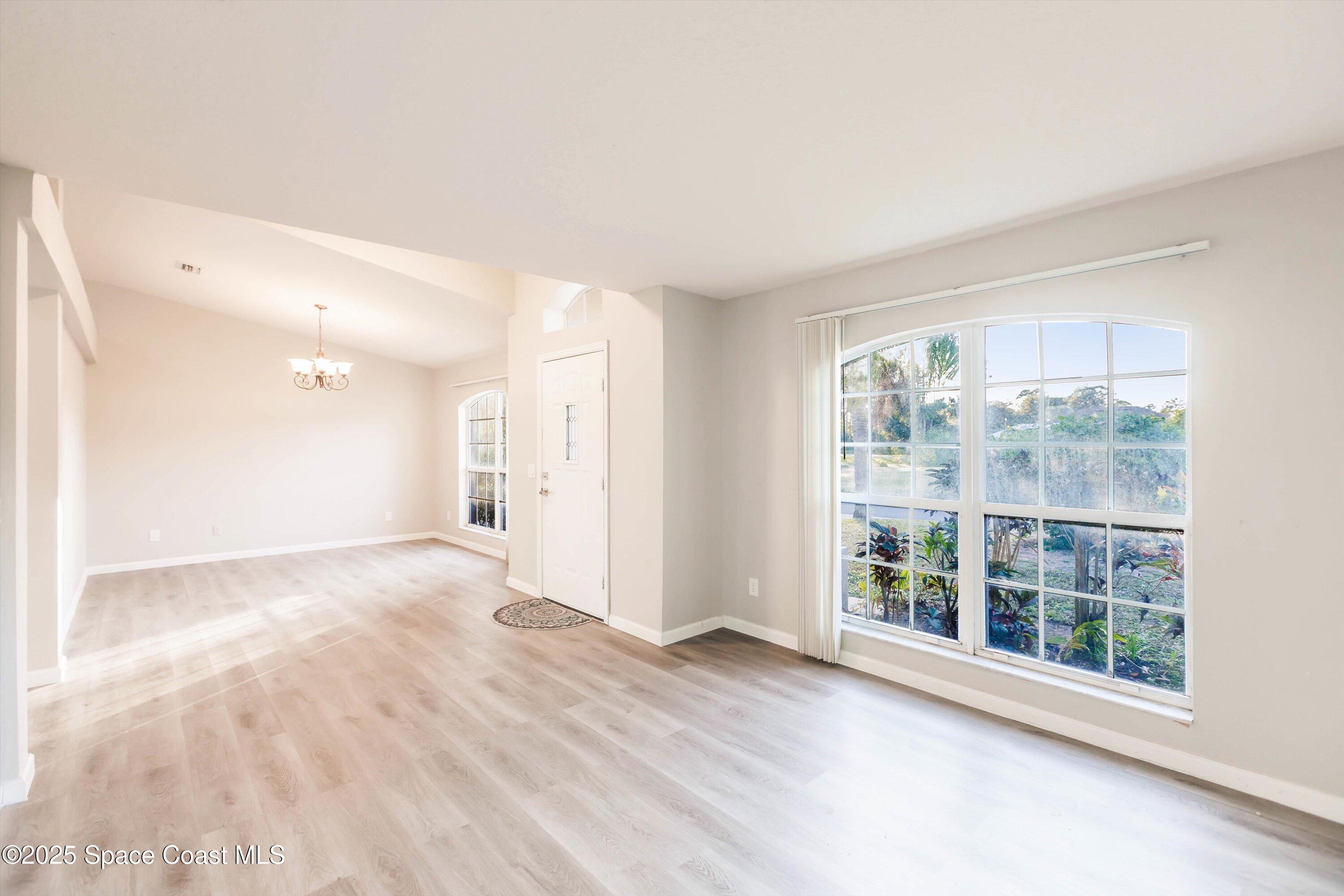 3061 Tazewell Avenue Southeast Palm Bay, FL 32909 - Photo 4 of 30 a view of an empty room with a window