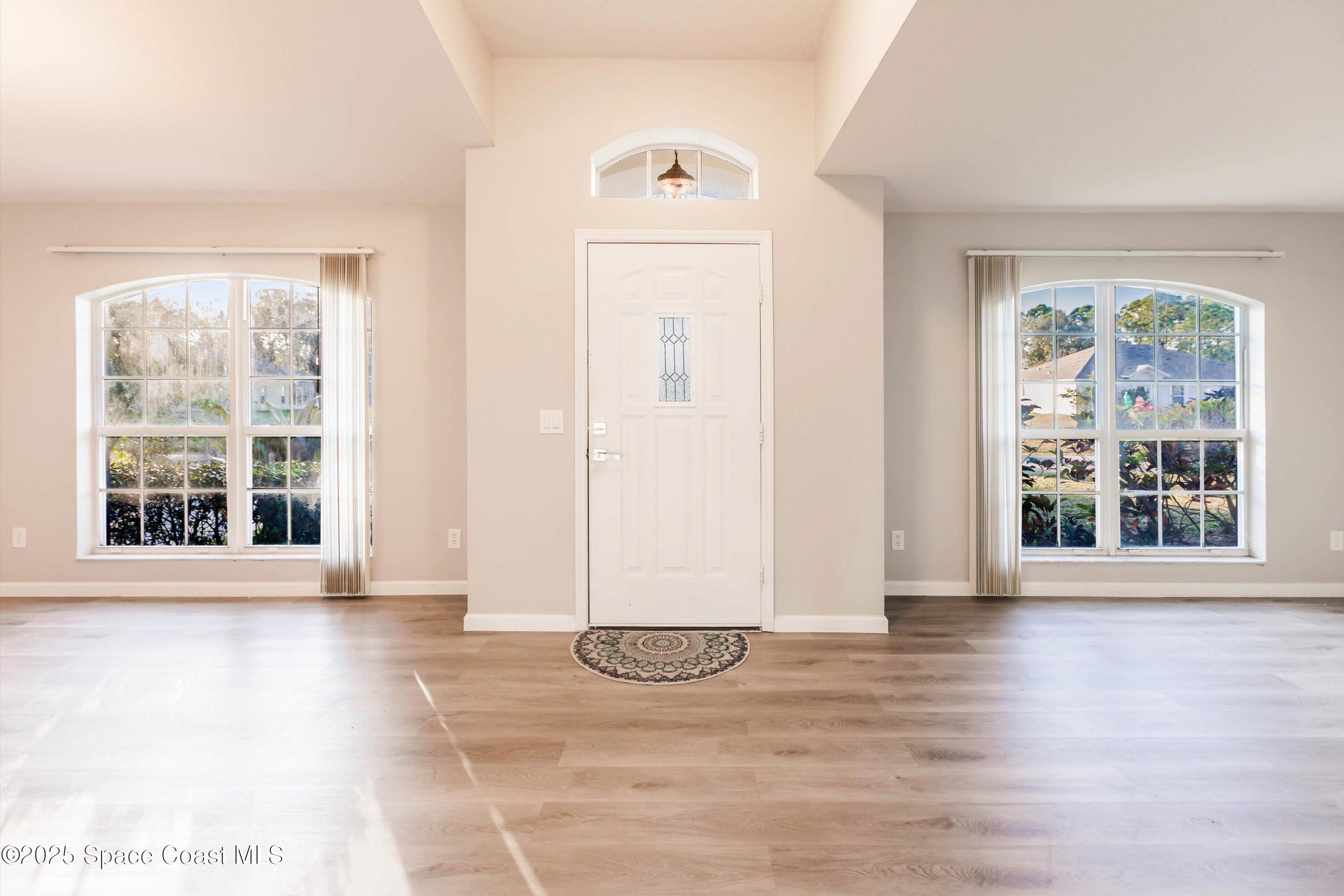 3061 Tazewell Avenue Southeast Palm Bay, FL 32909 - Photo 5 of 30 a view of a livingroom with wooden floor and a large window