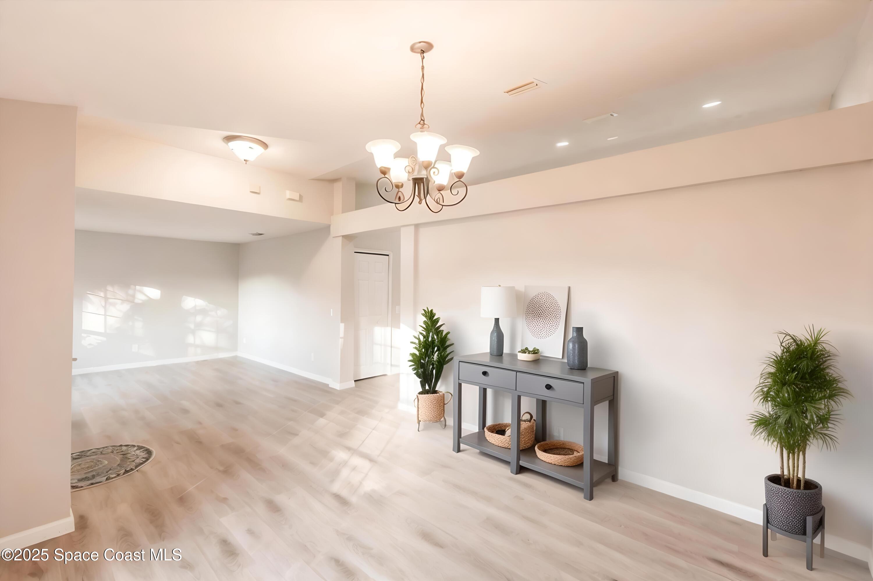 3061 Tazewell Avenue Southeast Palm Bay, FL 32909 - Photo 8 of 30 a view of a dining room with furniture and a chandelier