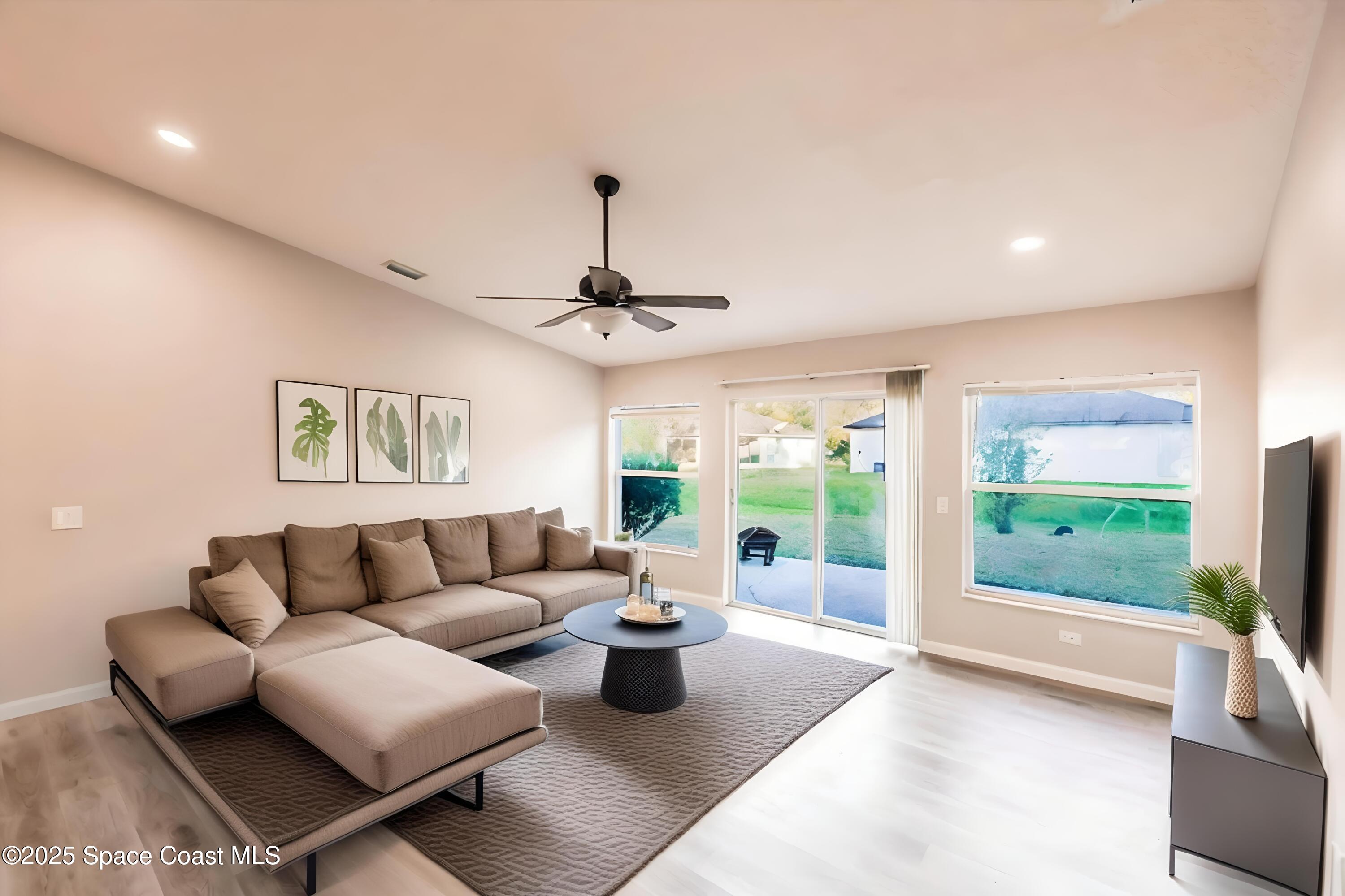 3061 Tazewell Avenue Southeast Palm Bay, FL 32909 - Photo 10 of 30 a living room with furniture and a flat screen tv