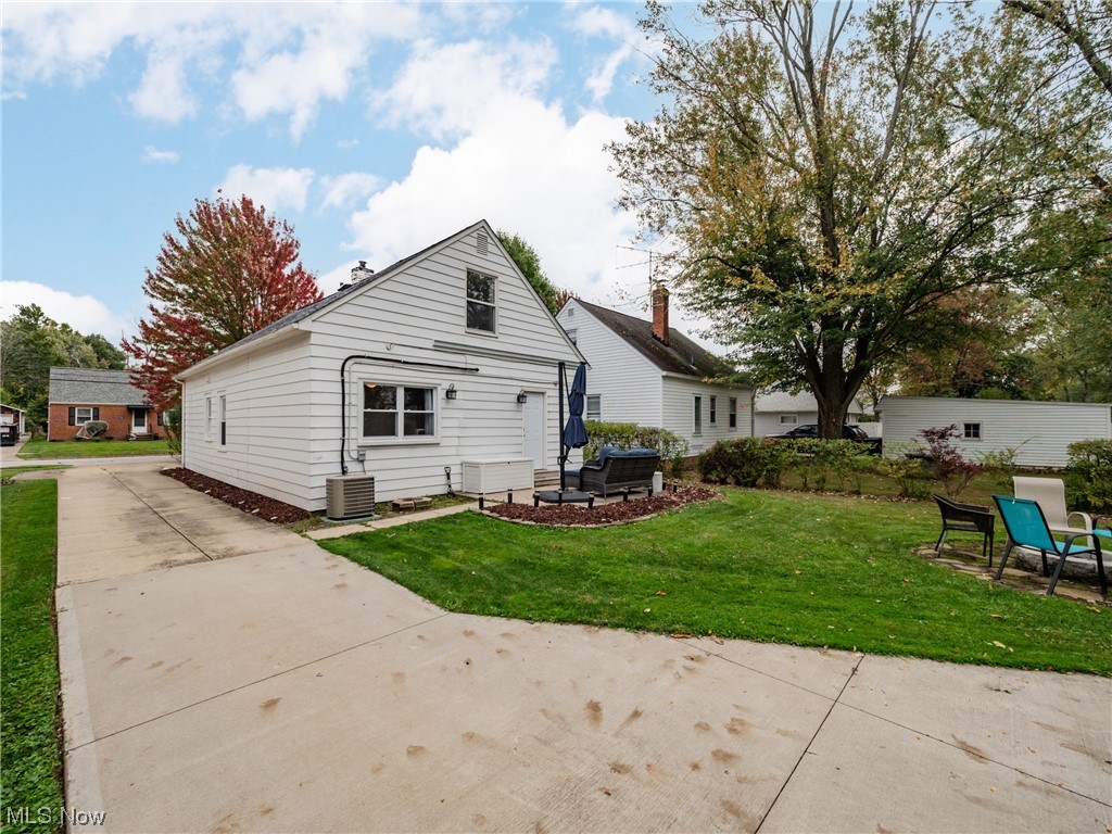 1240 Churchill Road Lyndhurst, OH 44124 - Photo 25 of 30 Rear view of property featuring central AC, a patio area, and a yard