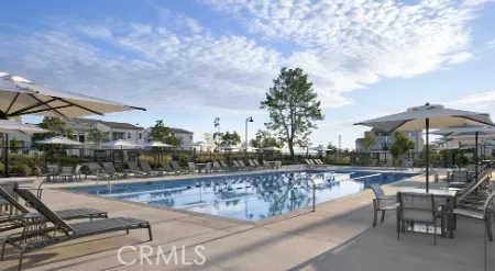 a view of a swimming pool with a patio and a yard