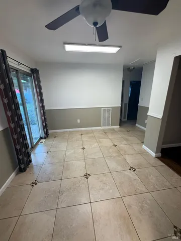 a view of a livingroom with an empty space and a stove