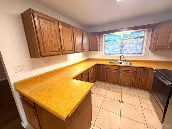 a kitchen with a sink and large window