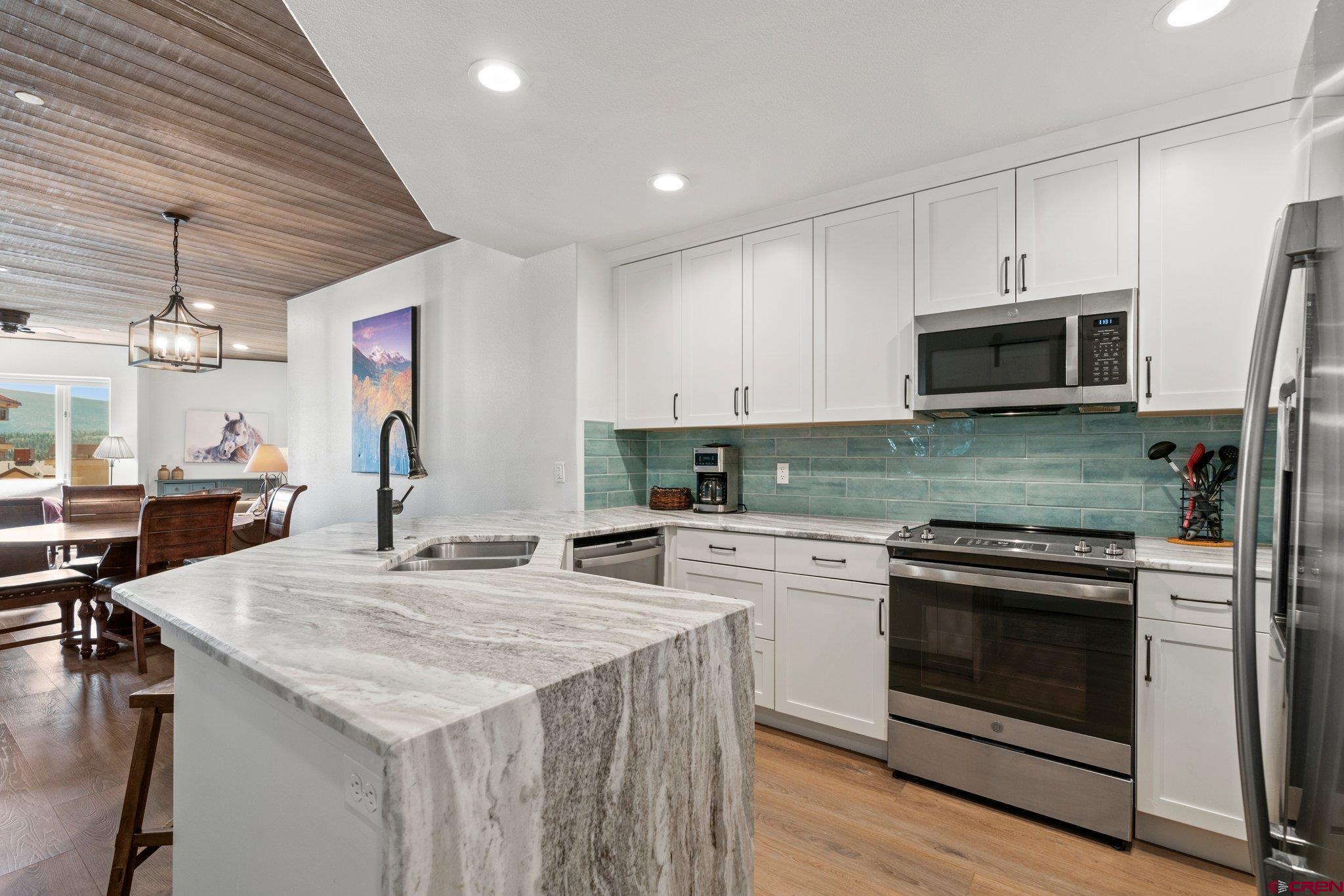 117 Needles Way, Unit 624 Durango, CO 81301 - Photo 2 of 32 a kitchen with a stove and a microwave