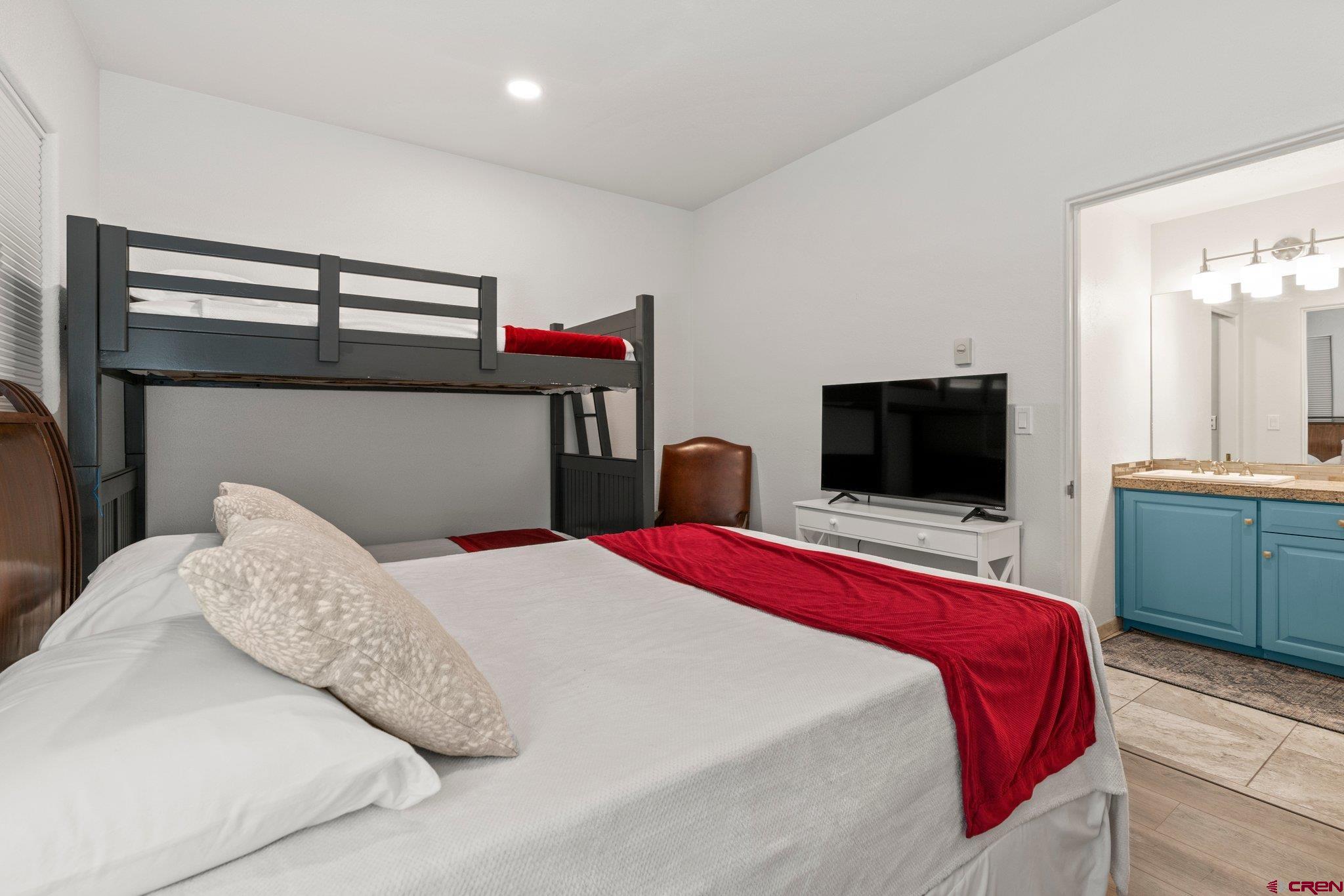 117 Needles Way, Unit 624 Durango, CO 81301 - Photo 8 of 32 a bedroom with a bed and a flat screen tv