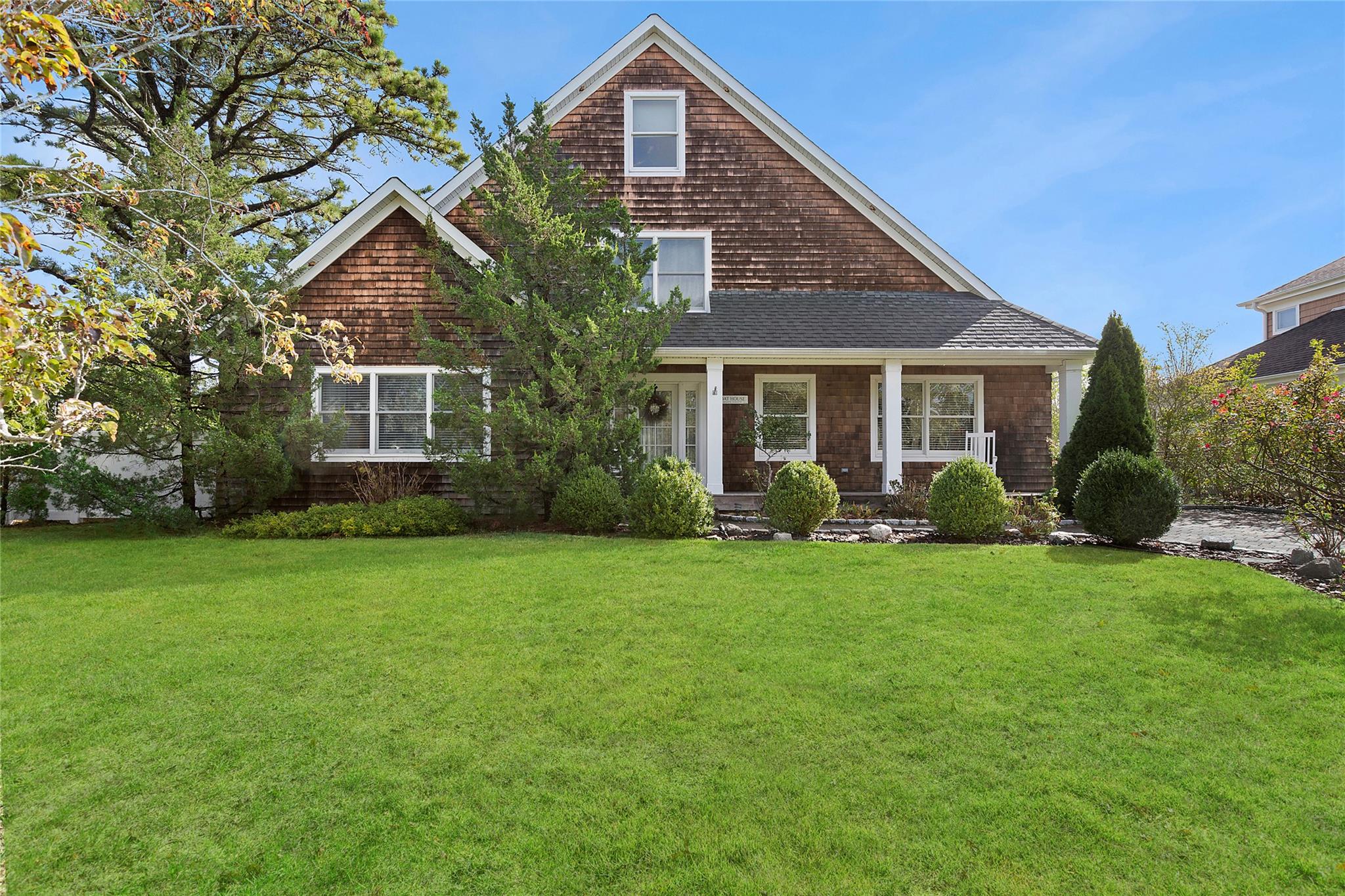 Front facade with a front yard and covered porch