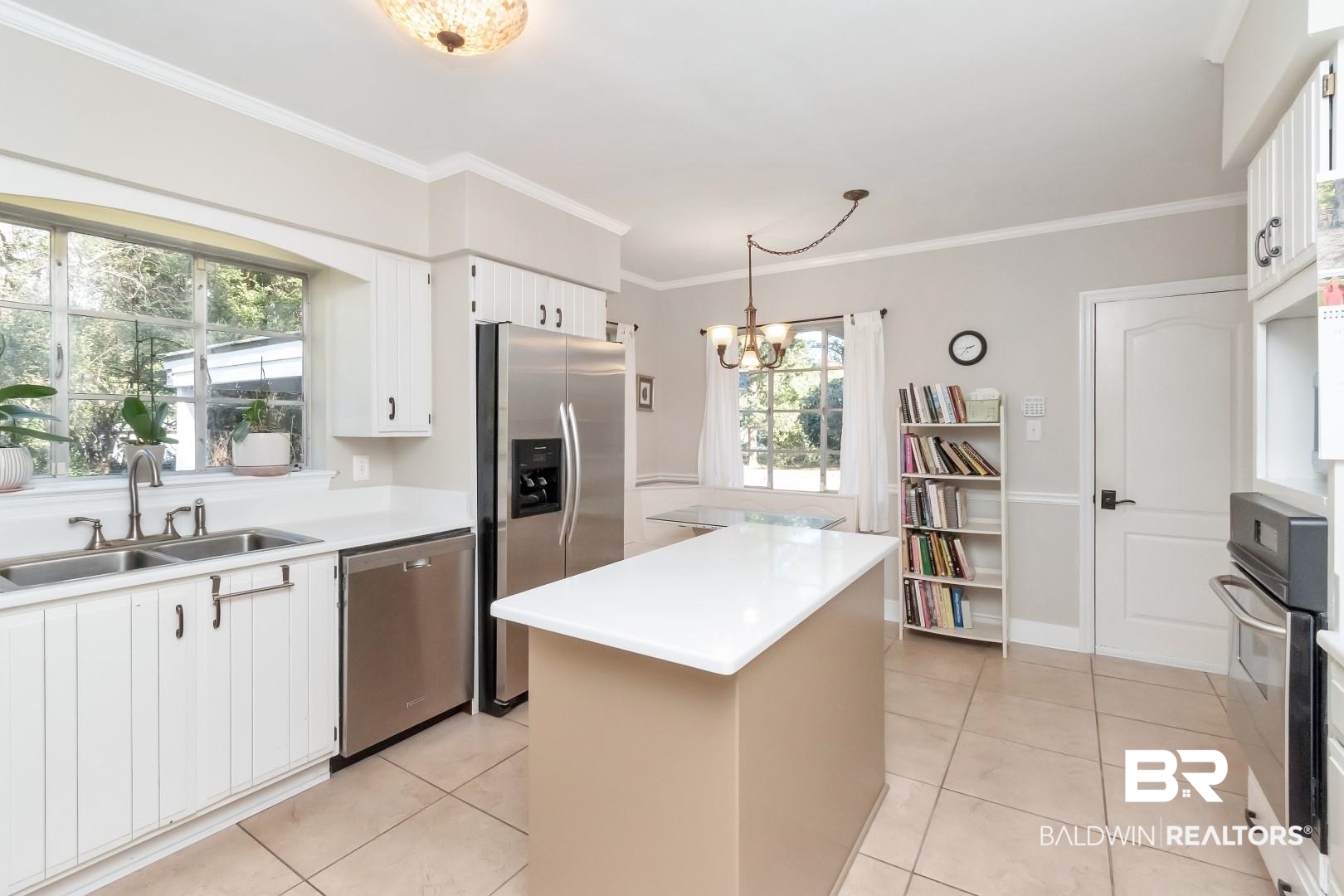 302 Springwood Drive East Mobile, AL 36608 - Photo 13 of 35 Kitchen with a center island, decorative light fixtures, appliances with stainless steel finishes, a notable chandelier, and white cabinetry