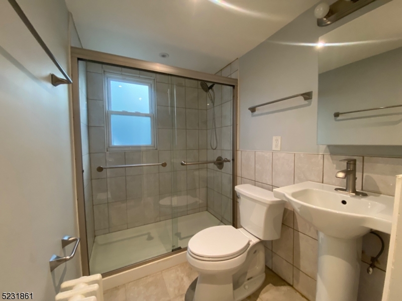 24 East 7th Street, Unit 2 Clifton, NJ 07011 - Photo 4 of 5 a bathroom with a sink toilet and shower