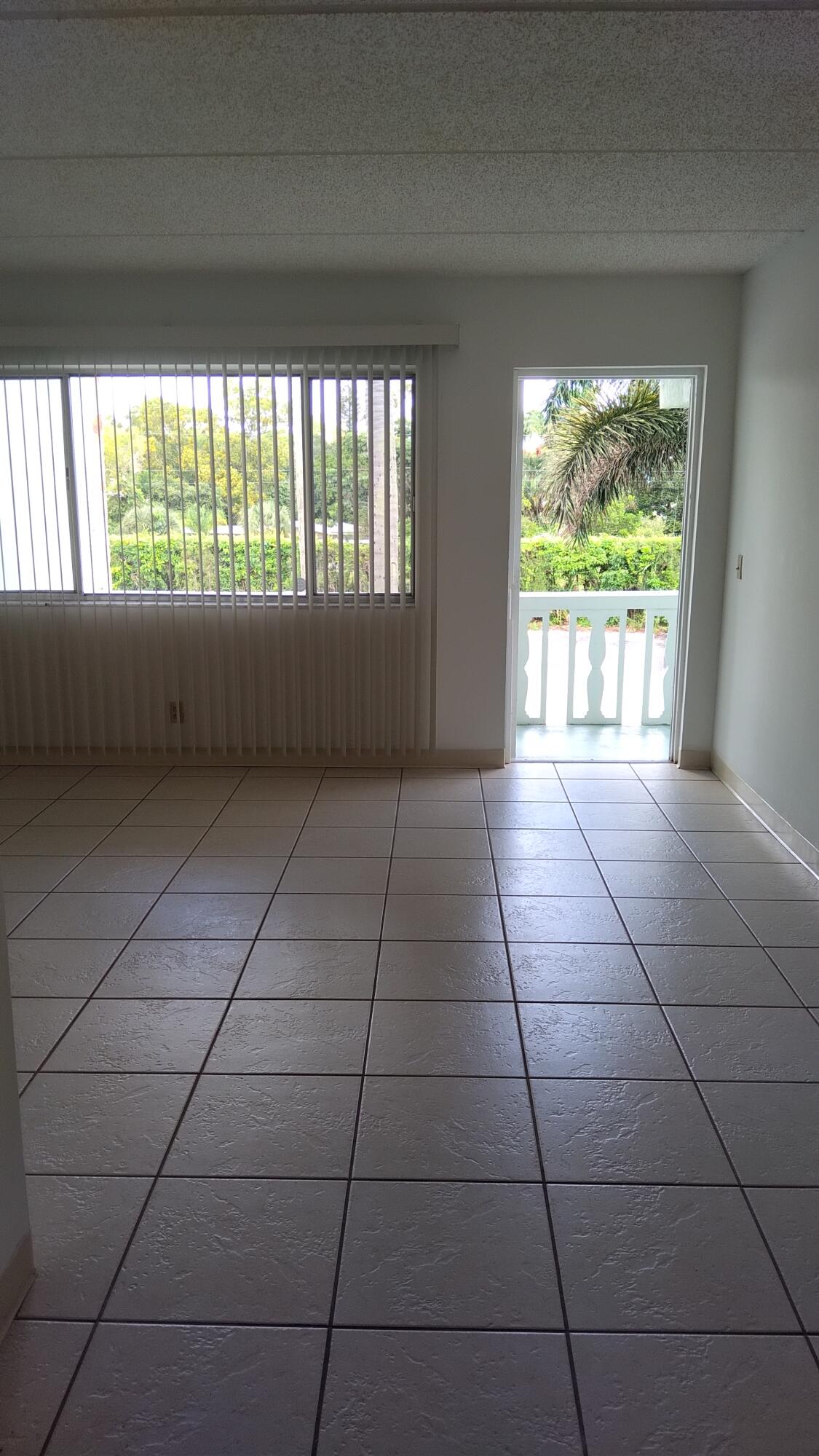 3300 Springdale Boulevard, Unit 208 Palm Springs, FL 33461 - Photo 18 of 21 a view of an empty room with a window