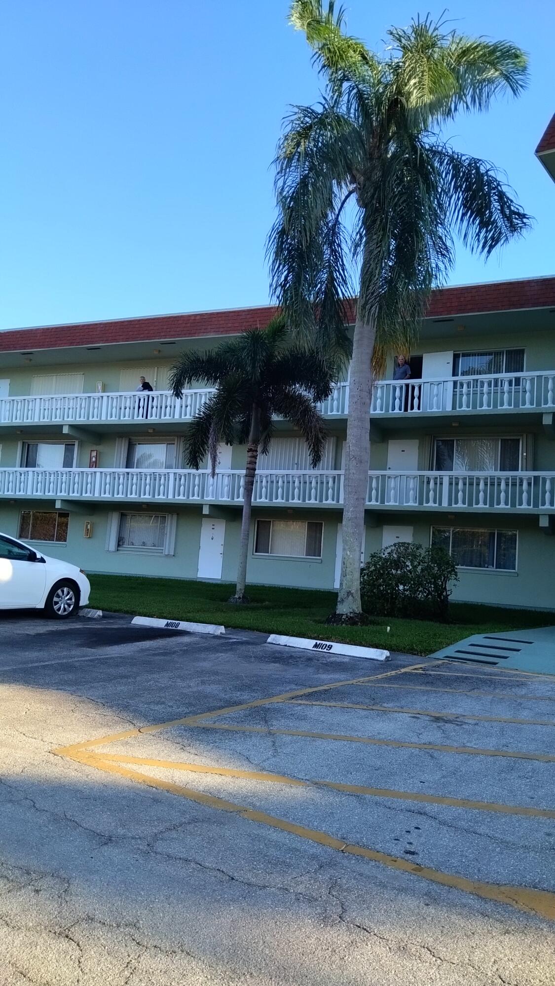 3300 Springdale Boulevard, Unit 208 Palm Springs, FL 33461 - Photo 3 of 21 a front view of a house with a yard