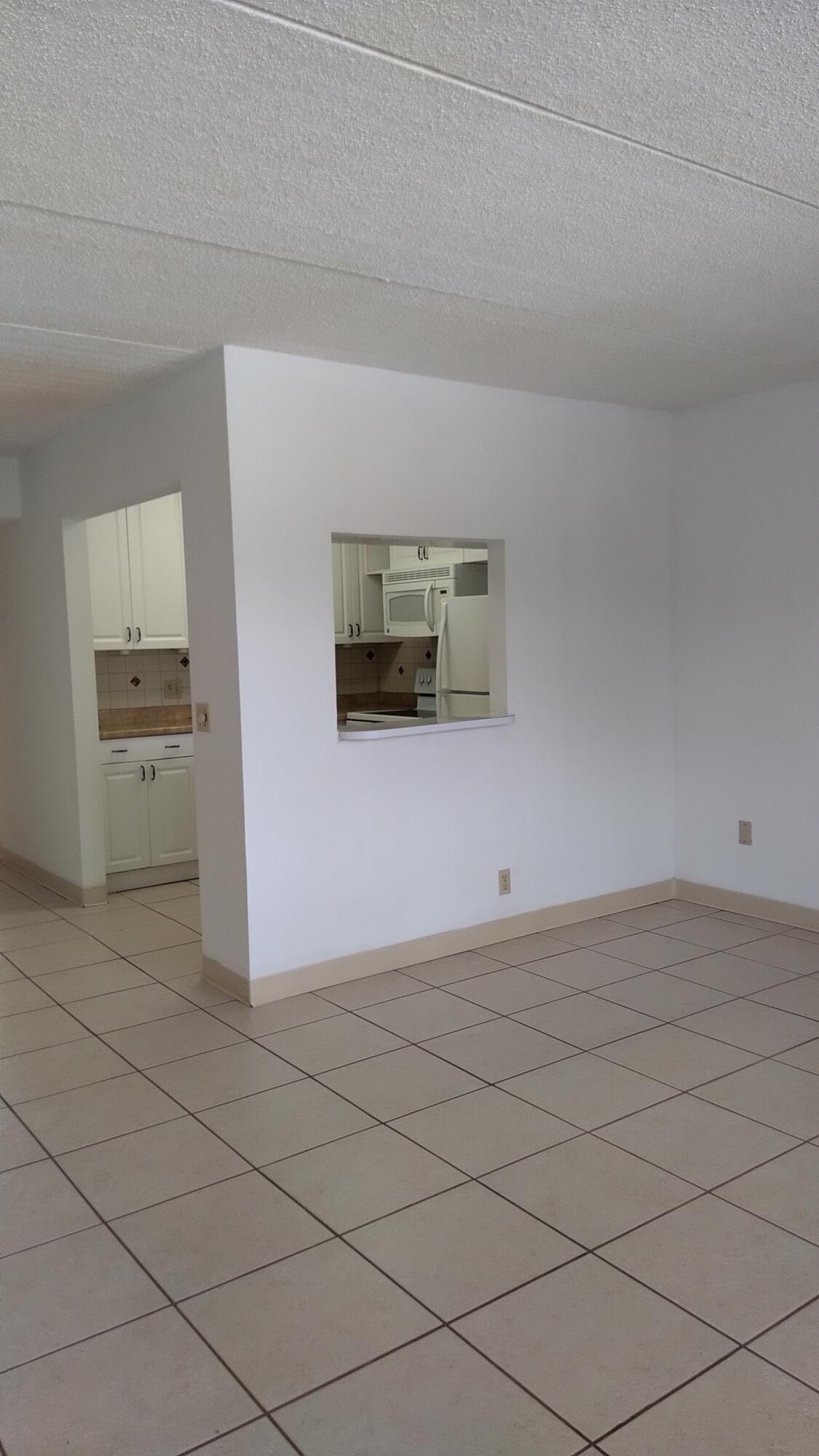 3300 Springdale Boulevard, Unit 208 Palm Springs, FL 33461 - Photo 8 of 21 a view of a livingroom with an empty space and a sink