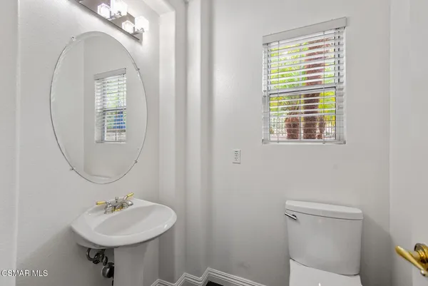 a bathroom with a sink a mirror and a toilet