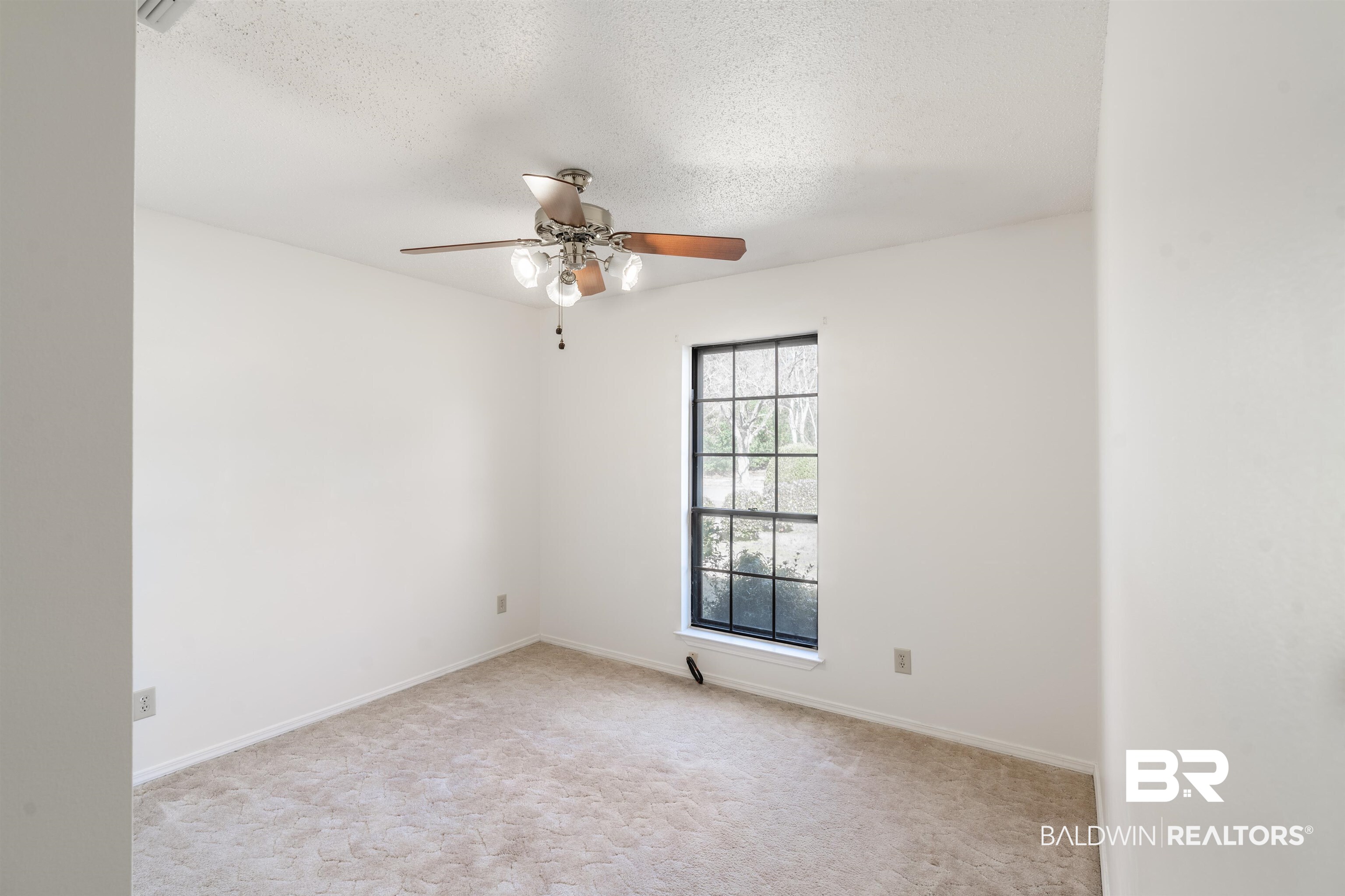 9751 Pine Knoll Road Mobile, AL 36608 - Photo 21 of 36 Spare room featuring light colored carpet, a ceiling fan, and a textured ceiling