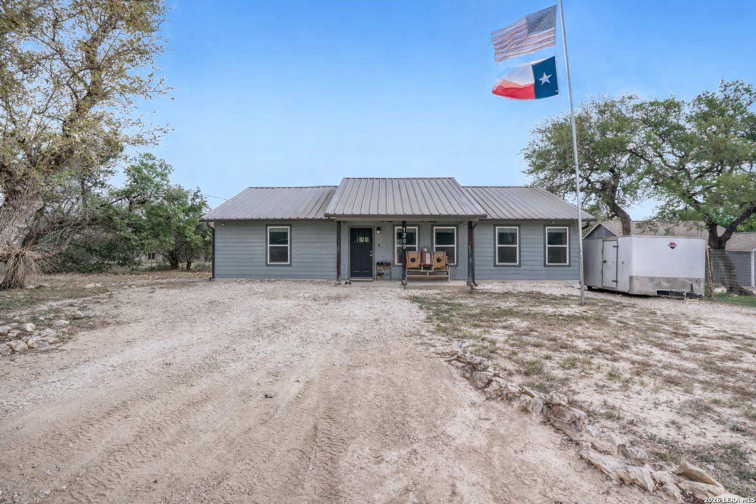 1209 Covered Wagon Spring Branch, TX 78070 - Photo 1 of 29 a front view of a house with a garden