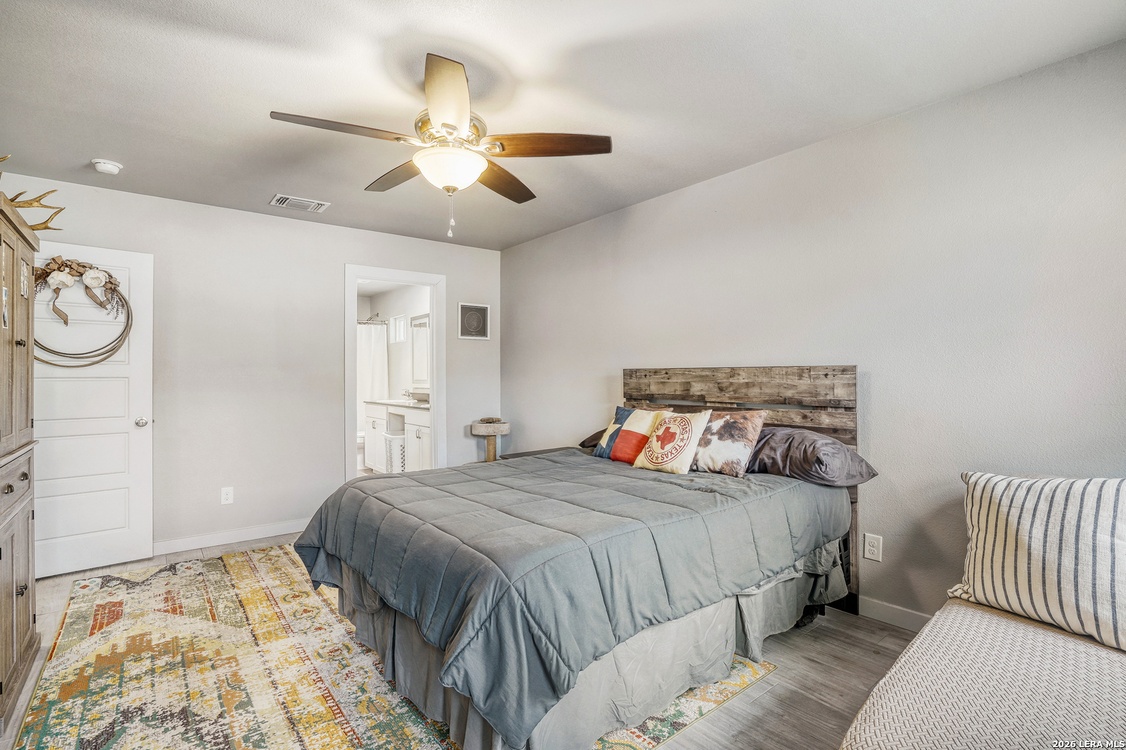 1209 Covered Wagon Spring Branch, TX 78070 - Photo 12 of 29 a bedroom with a large bed and a chandelier