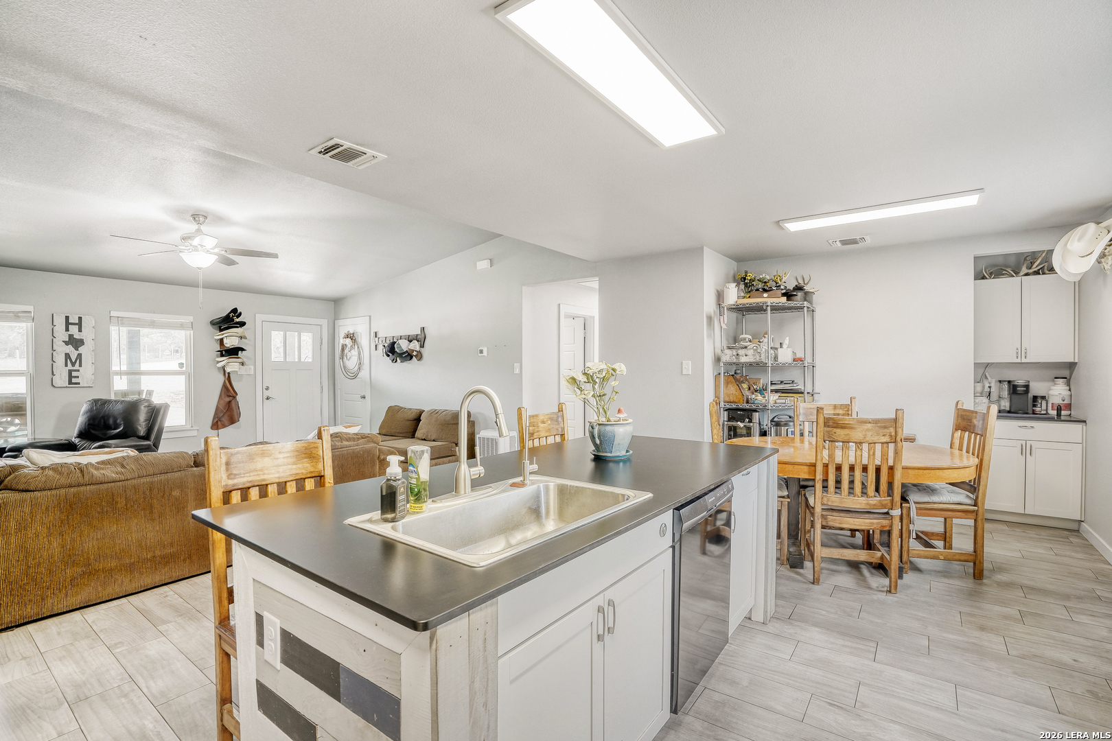 1209 Covered Wagon Spring Branch, TX 78070 - Photo 14 of 29 a kitchen with granite countertop a sink and chairs