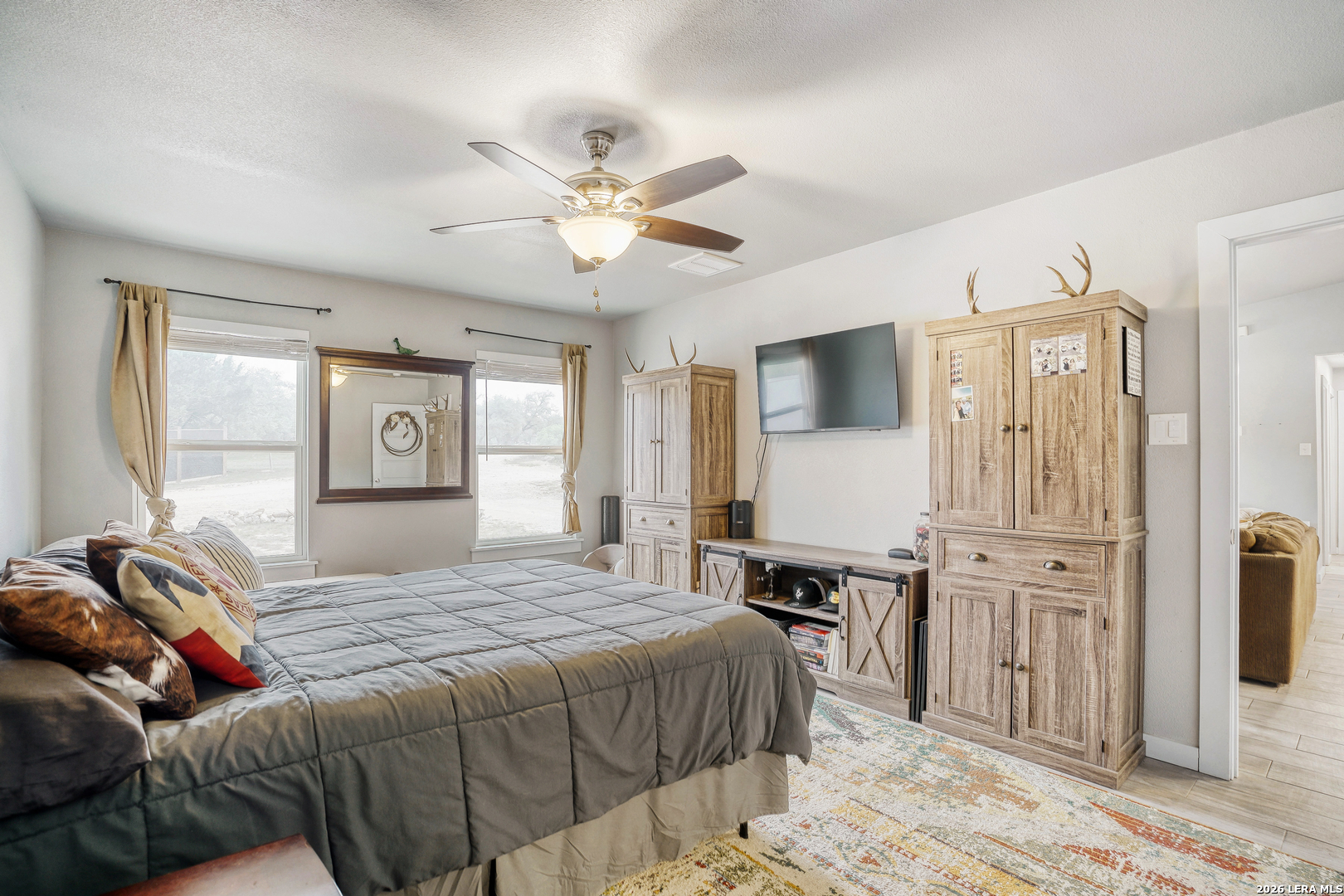 1209 Covered Wagon Spring Branch, TX 78070 - Photo 15 of 29 a bedroom with a bed and wooden floor