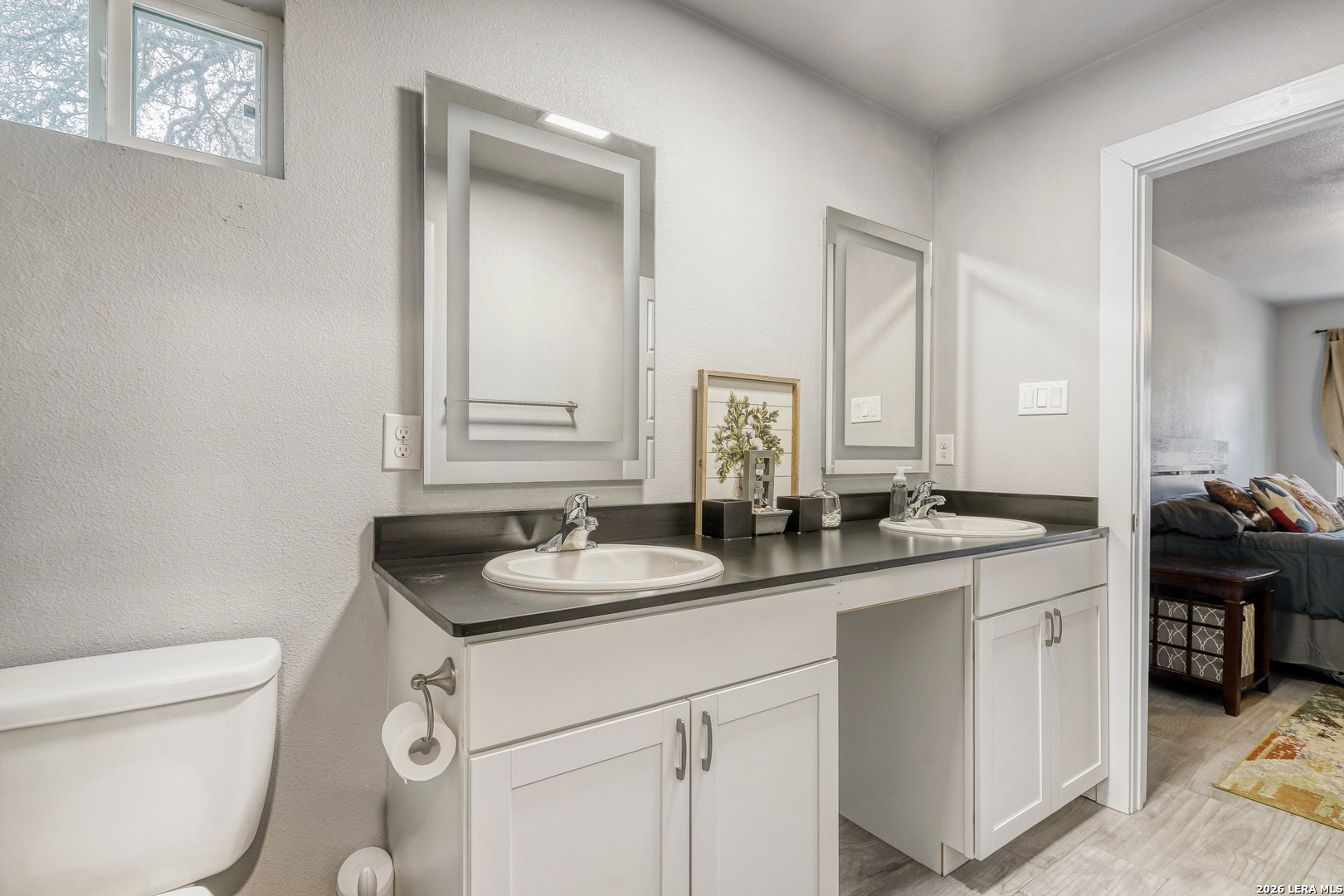 1209 Covered Wagon Spring Branch, TX 78070 - Photo 17 of 29 a bathroom with a granite countertop sink toilet and mirror