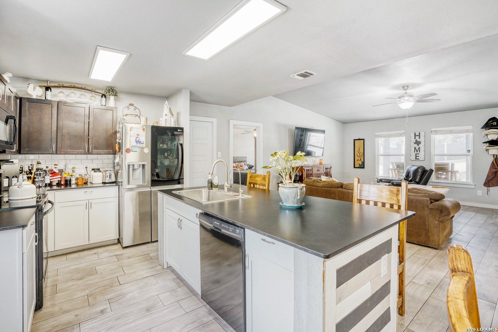 1209 Covered Wagon Spring Branch, TX 78070 - Photo 5 of 29 a kitchen with stainless steel appliances granite countertop a sink a stove and a refrigerator