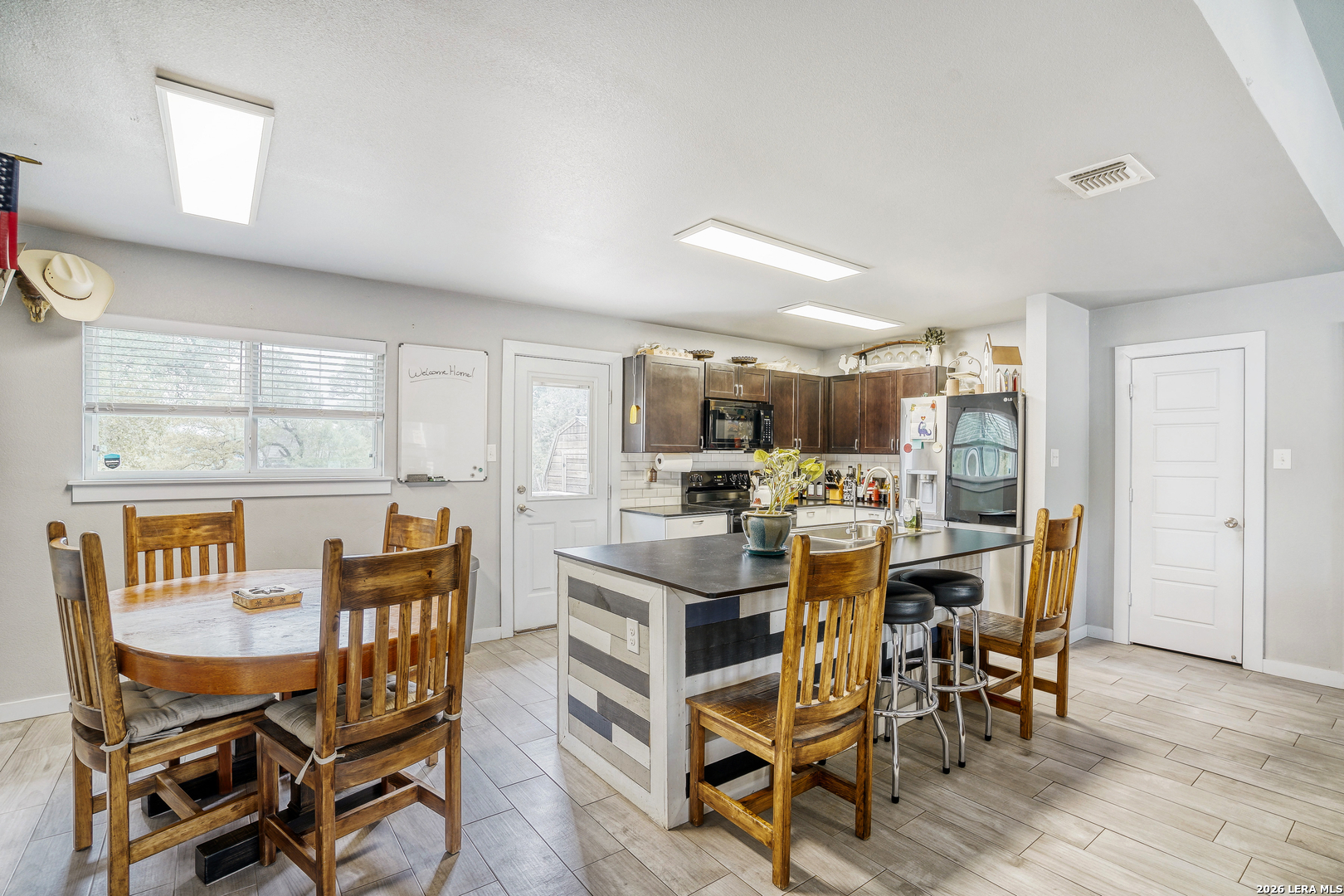 1209 Covered Wagon Spring Branch, TX 78070 - Photo 10 of 29 a view of a dining room with furniture and wooden floor