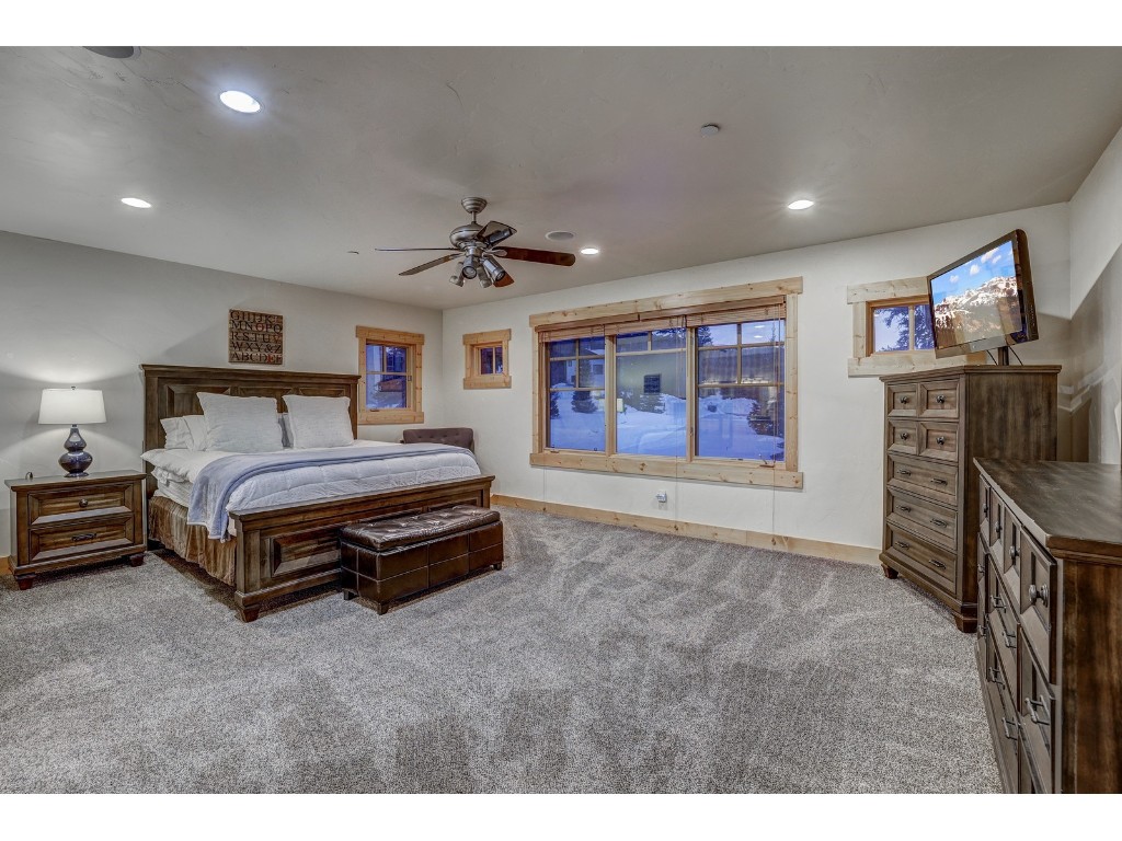 397 Whispering Pines Circle Blue River, CO 80424 - Photo 16 of 35 a spacious bedroom with a bed and a desk
