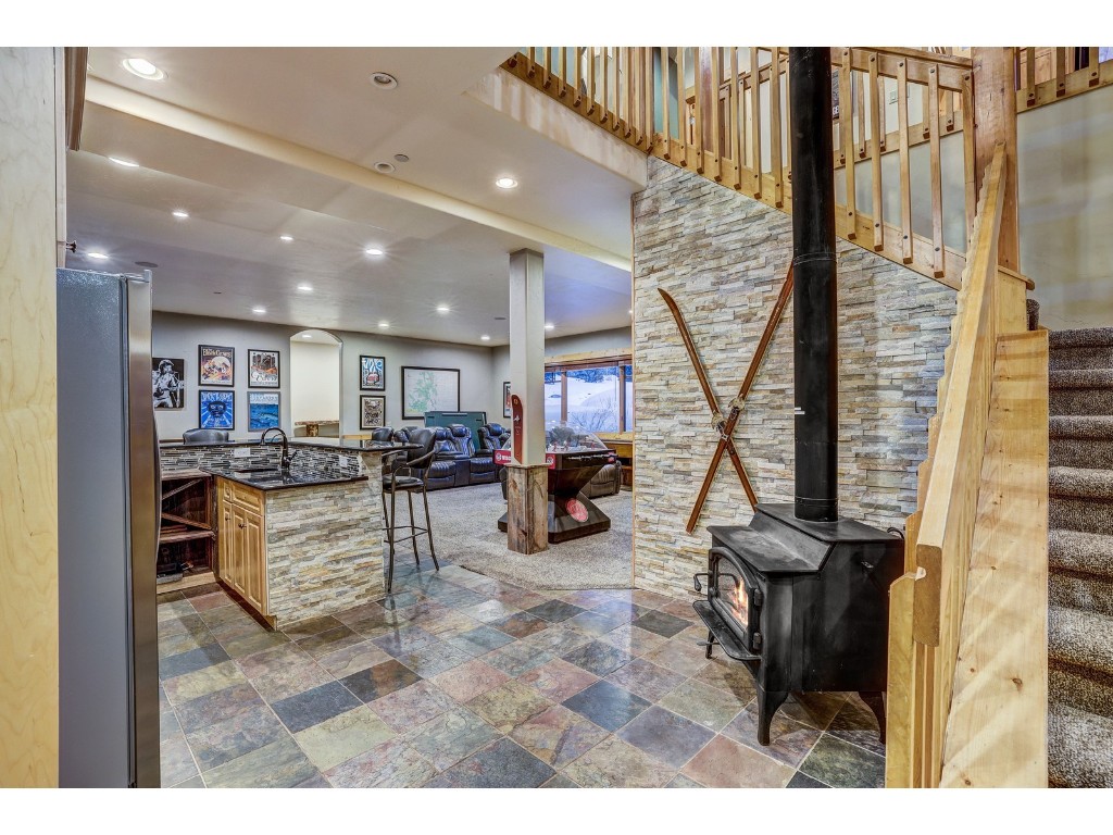 397 Whispering Pines Circle Blue River, CO 80424 - Photo 21 of 35 a living room with furniture a flat screen tv and a table