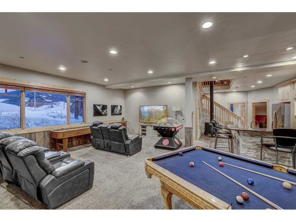 397 Whispering Pines Circle Blue River, CO 80424 - Photo 22 of 35 a living room with furniture and a flat screen tv