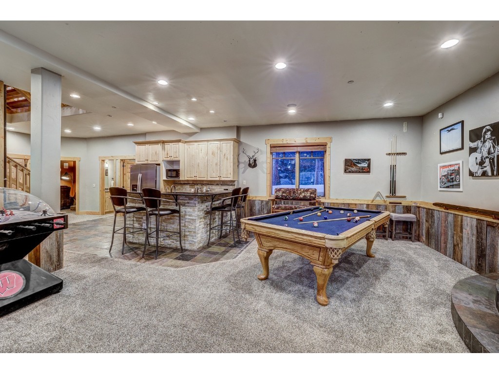 397 Whispering Pines Circle Blue River, CO 80424 - Photo 23 of 35 a living room with lots of furniture and a table