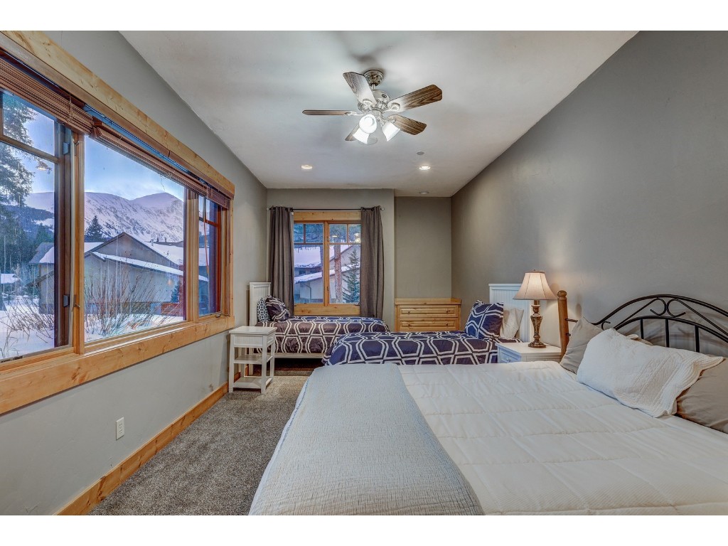 397 Whispering Pines Circle Blue River, CO 80424 - Photo 28 of 35 a bedroom with furniture and a large window