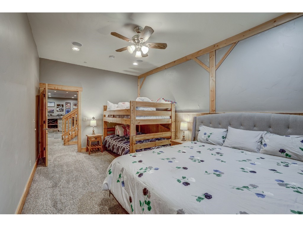 397 Whispering Pines Circle Blue River, CO 80424 - Photo 30 of 35 a bedroom with a bed and a chandelier