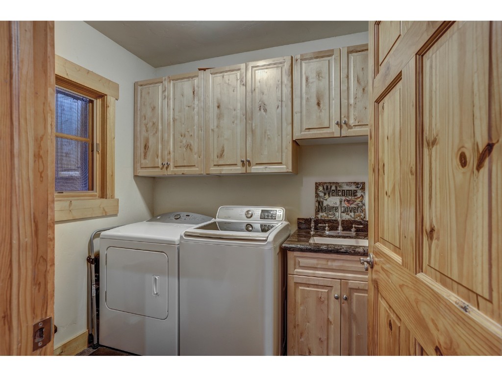 397 Whispering Pines Circle Blue River, CO 80424 - Photo 32 of 35 a kitchen with stainless steel appliances granite countertop a stove a refrigerator and a microwave