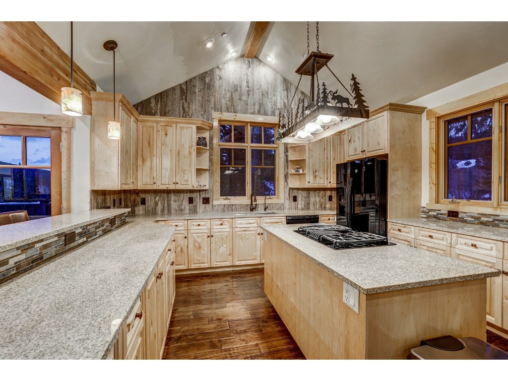 397 Whispering Pines Circle Blue River, CO 80424 - Photo 10 of 35 a kitchen with stainless steel appliances granite countertop a sink stove and refrigerator