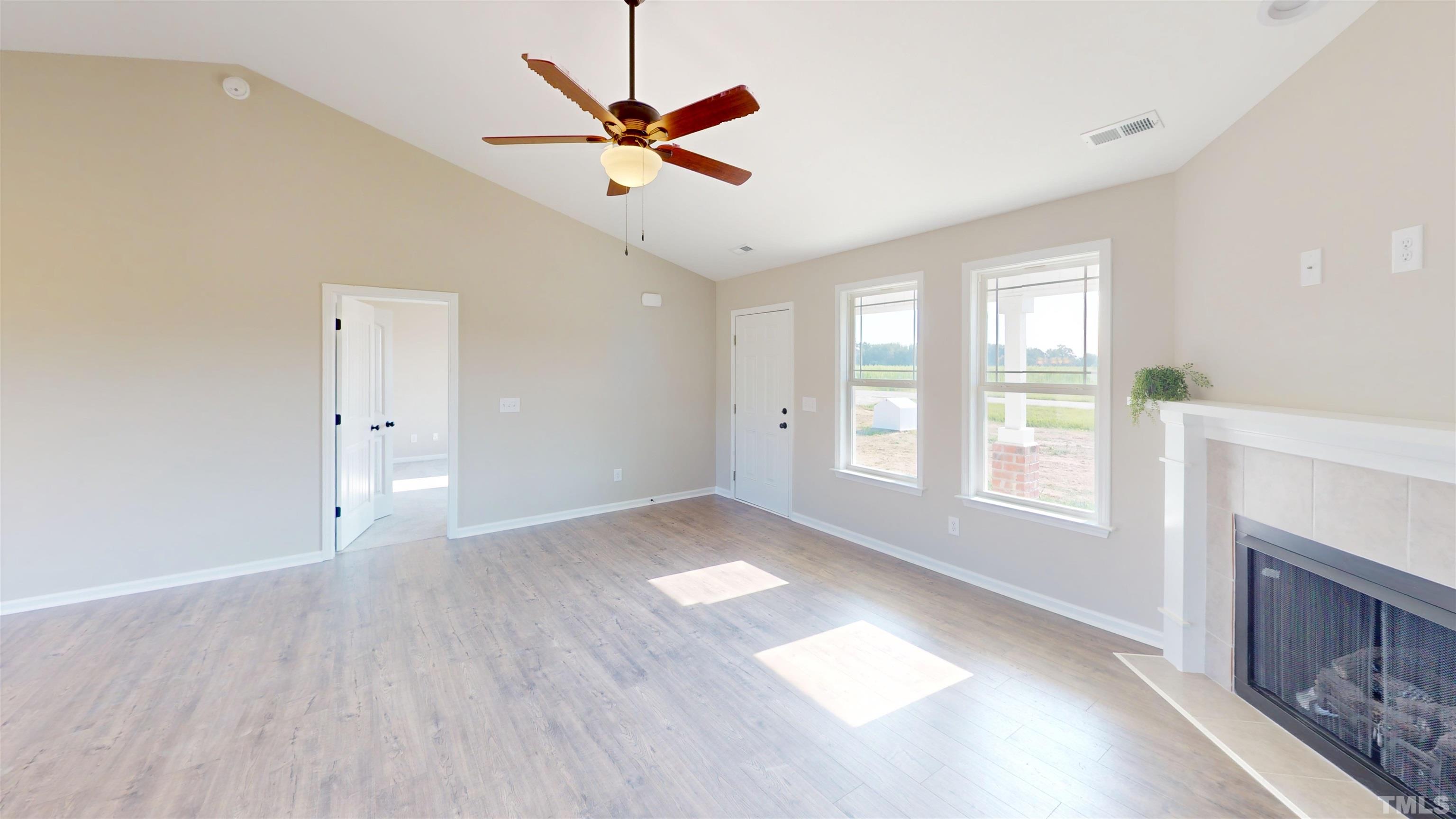 108 Mamie Road Benson, NC 27504 - Photo 12 of 31 a view of an empty room with a window and fireplace