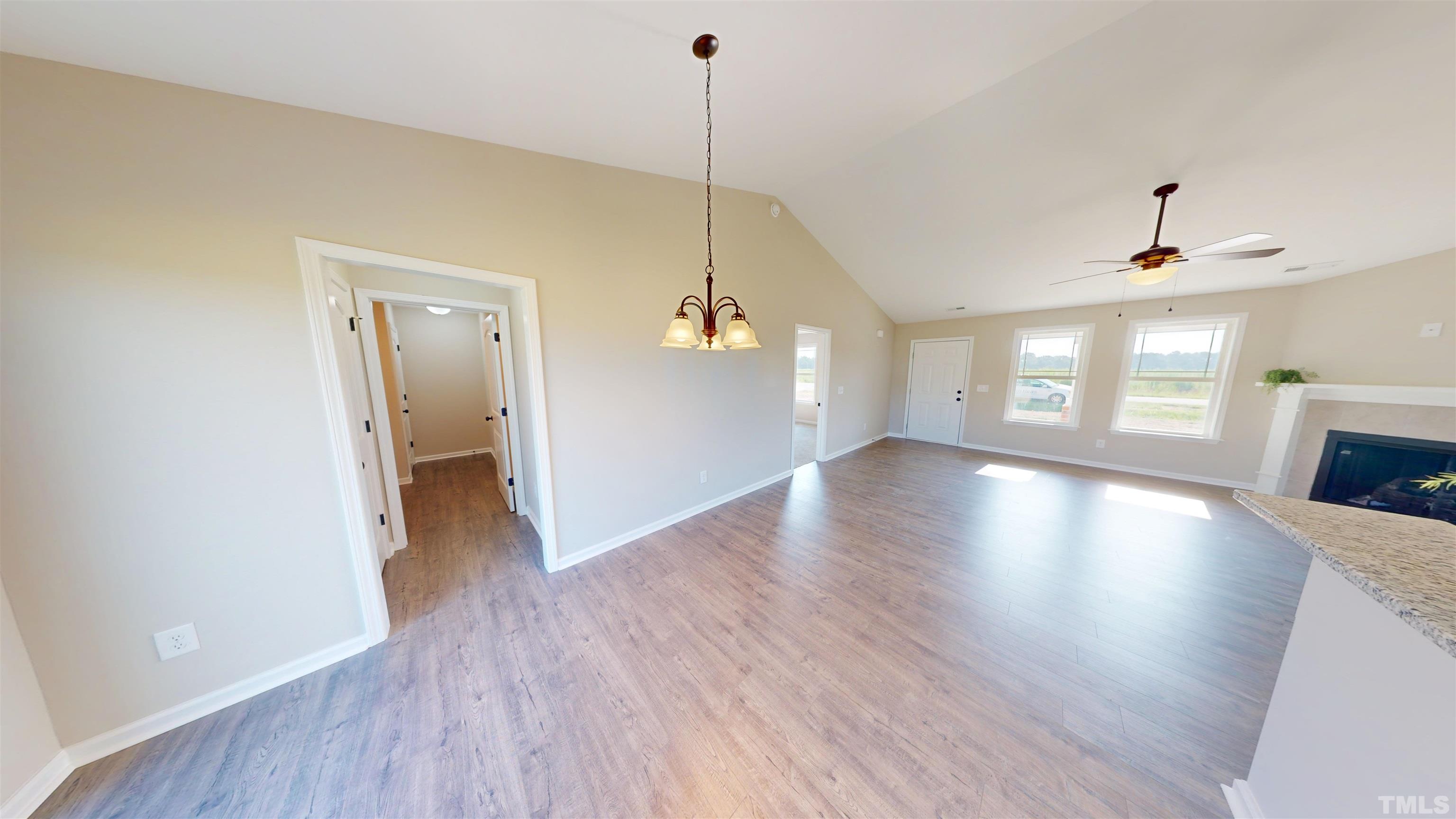 108 Mamie Road Benson, NC 27504 - Photo 13 of 31 a view of a room with wooden floor fireplace and windows