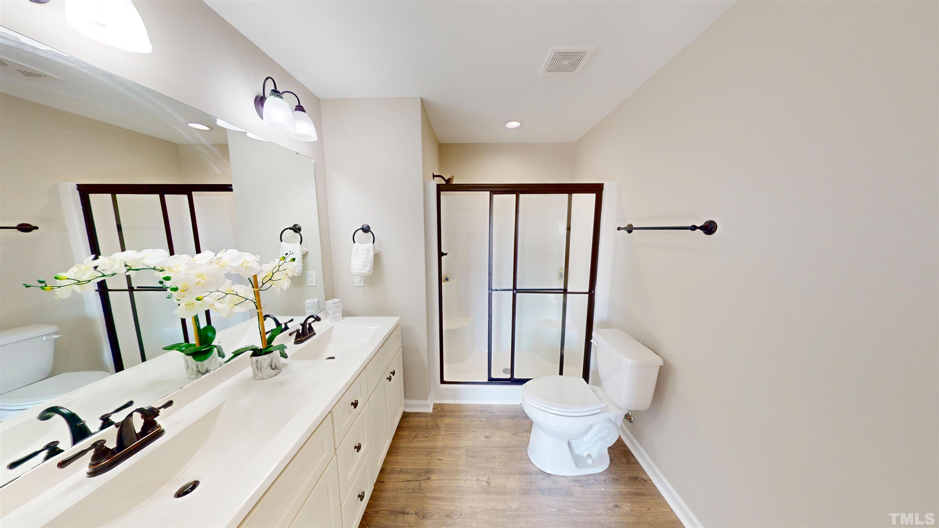 108 Mamie Road Benson, NC 27504 - Photo 16 of 31 a bathroom with a double vanity sink toilet and mirror