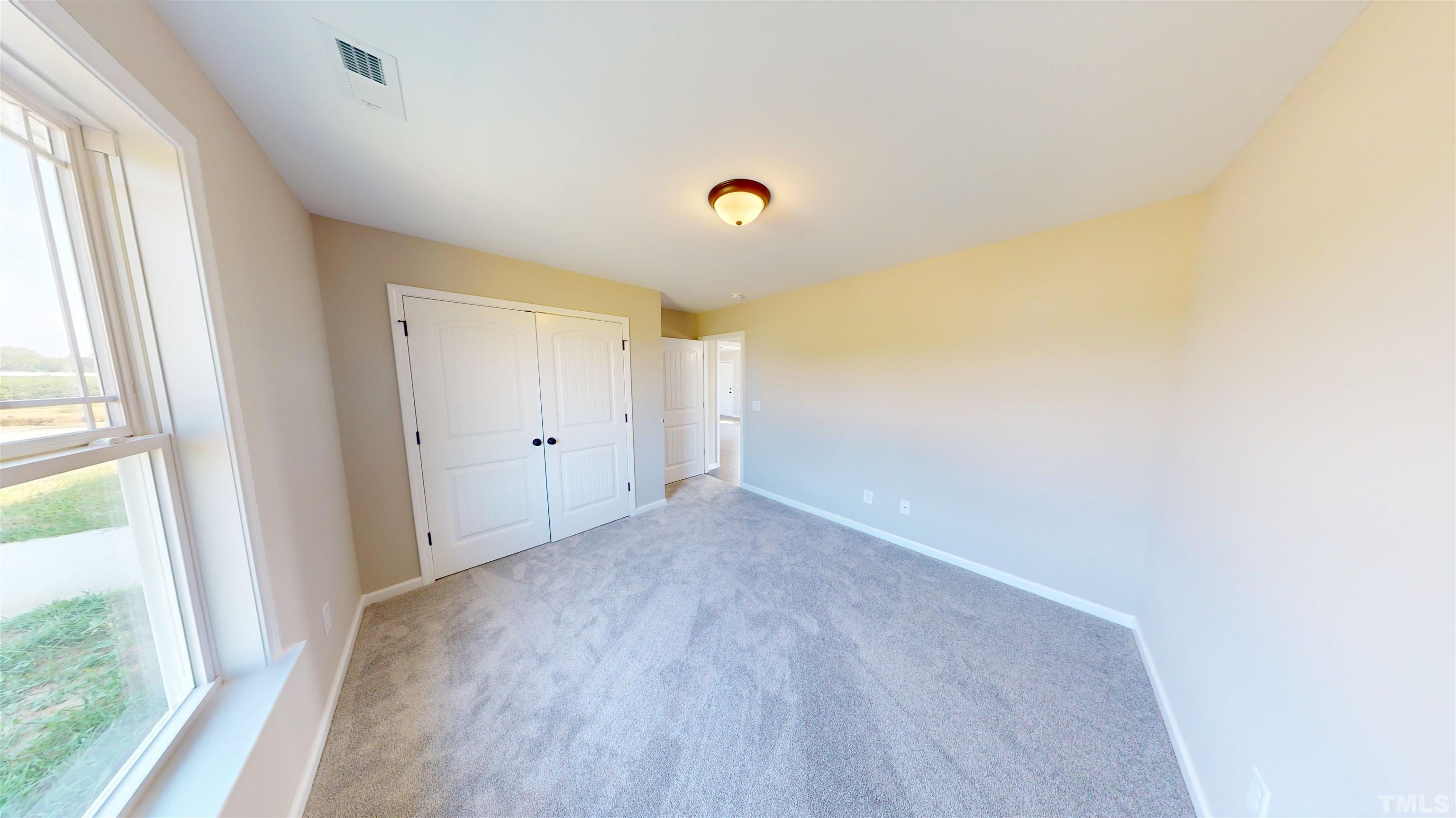 108 Mamie Road Benson, NC 27504 - Photo 23 of 31 a view of empty room with wooden floor and fan