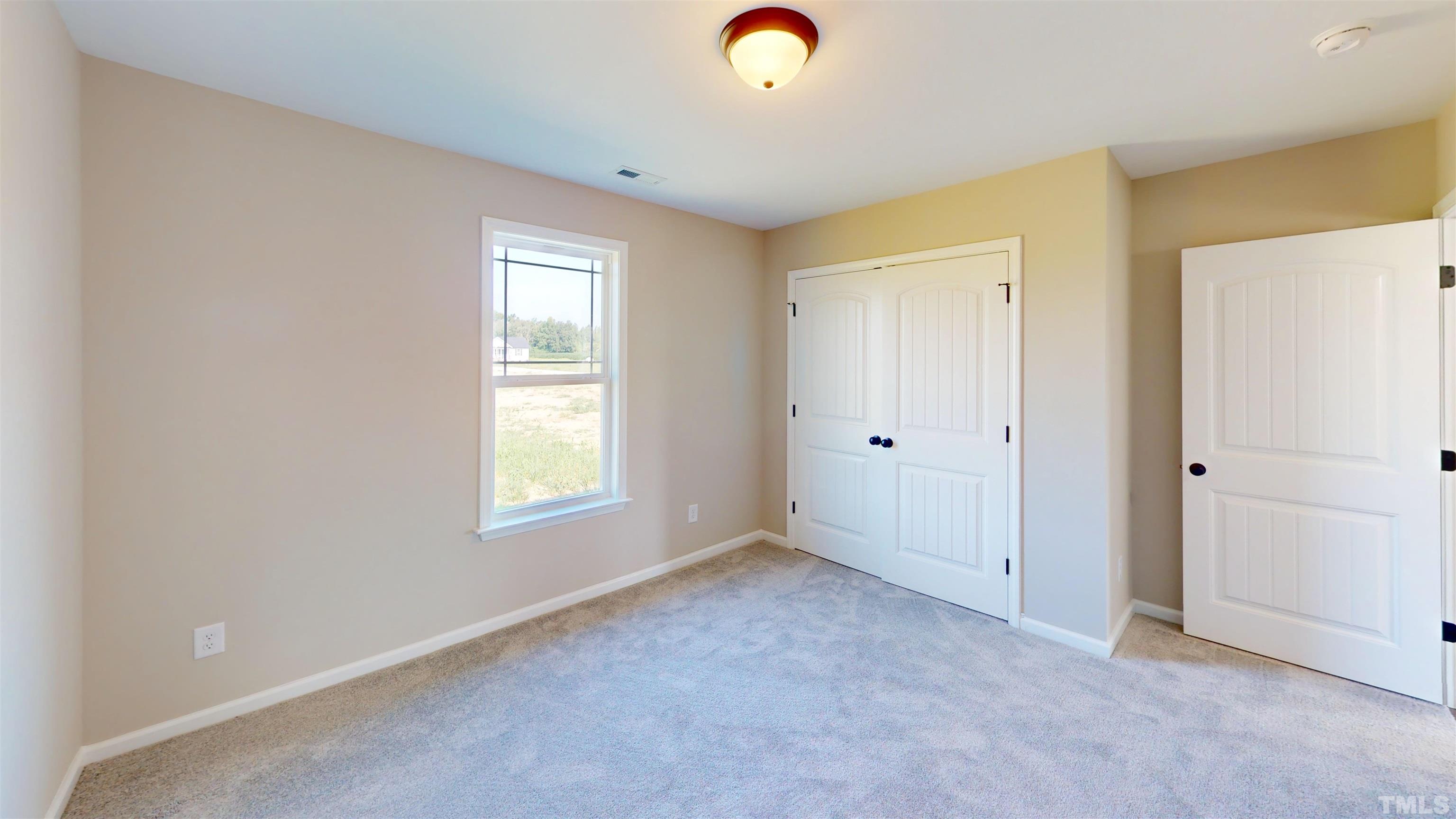 108 Mamie Road Benson, NC 27504 - Photo 24 of 31 an empty room with windows