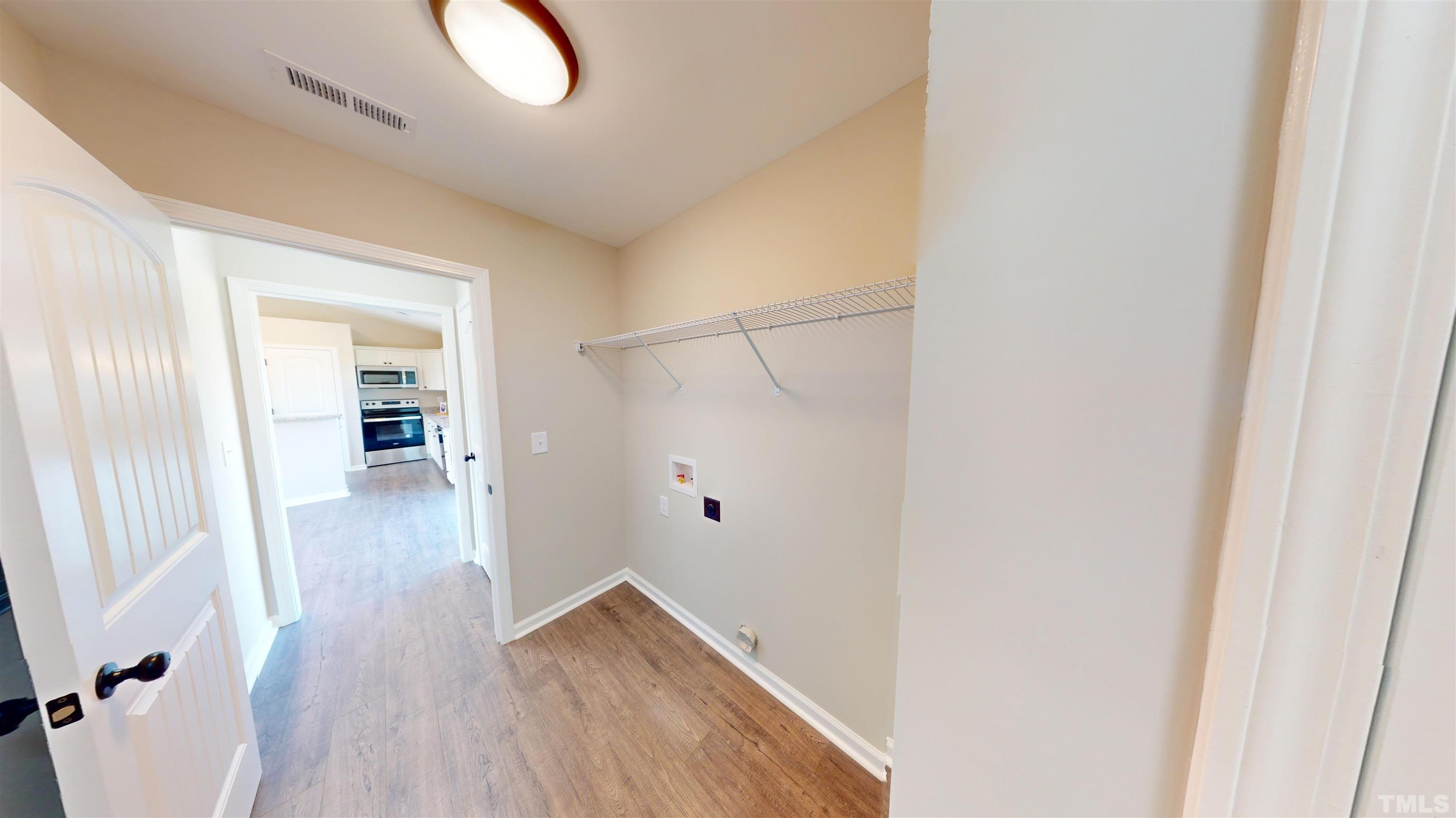 108 Mamie Road Benson, NC 27504 - Photo 26 of 31 a view of a hallway with wooden floor and closet
