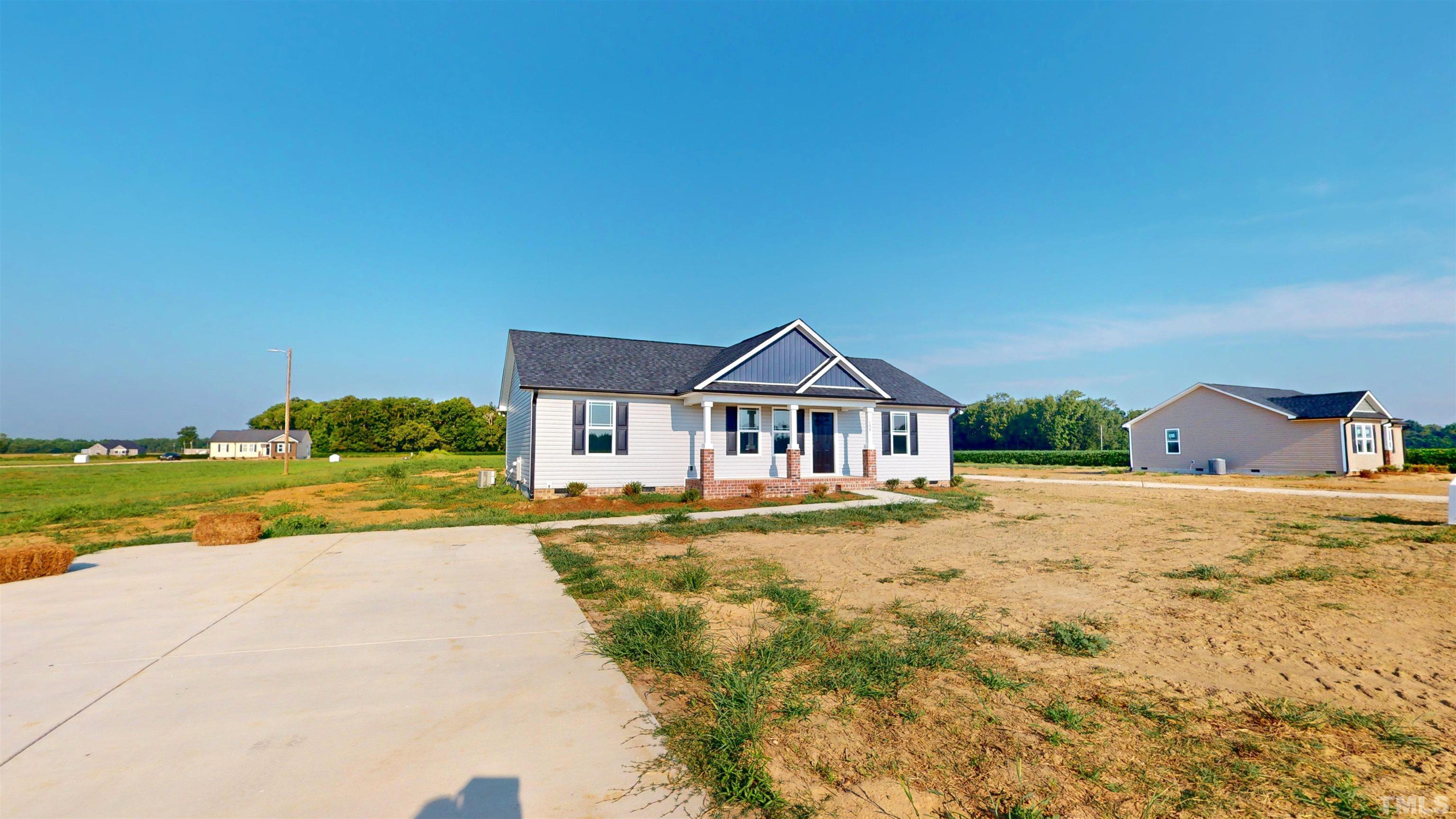 108 Mamie Road Benson, NC 27504 - Photo 3 of 31 a front view of a house with a yard
