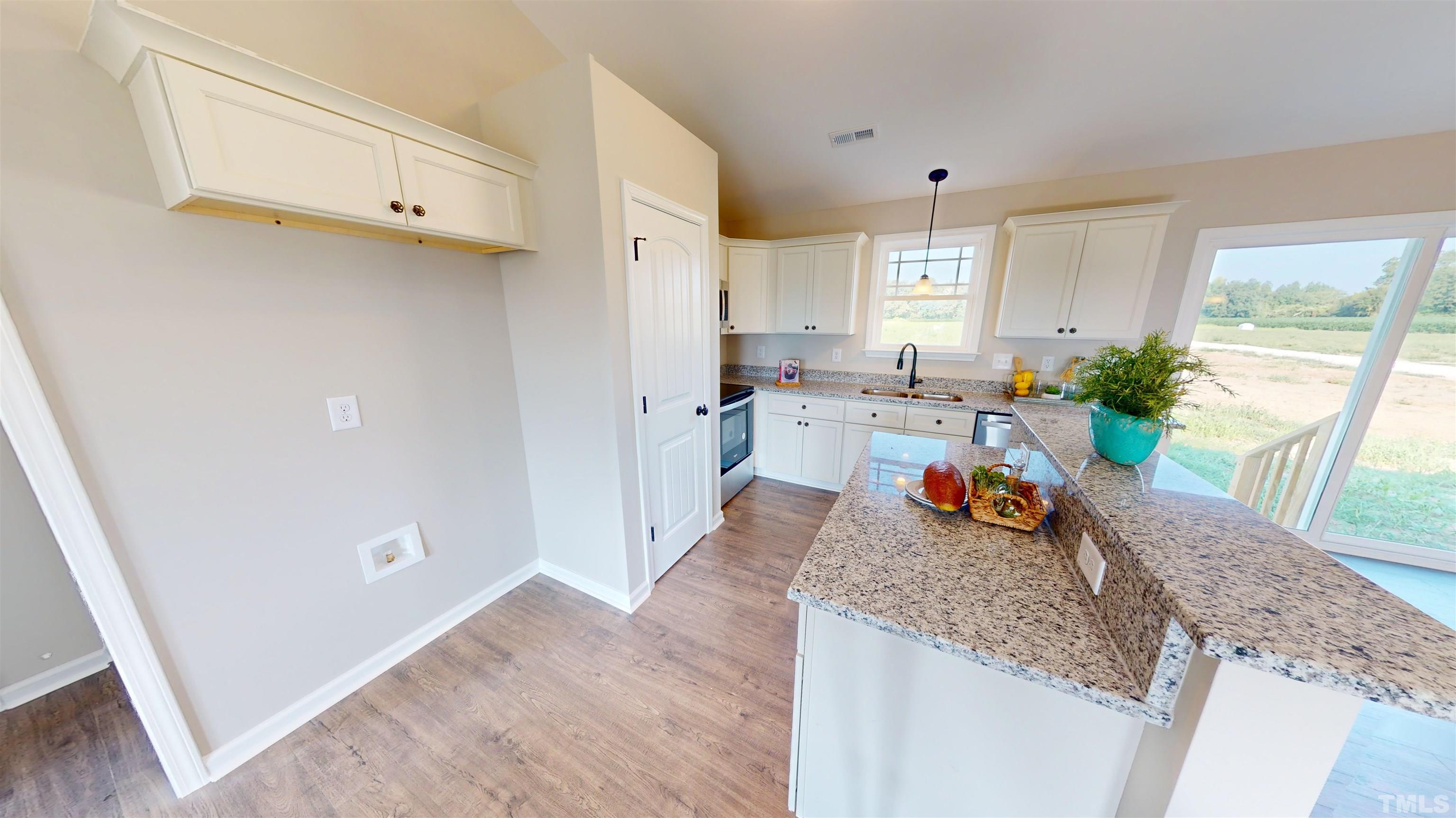 108 Mamie Road Benson, NC 27504 - Photo 7 of 31 a kitchen with granite countertop a stove a sink and a refrigerator