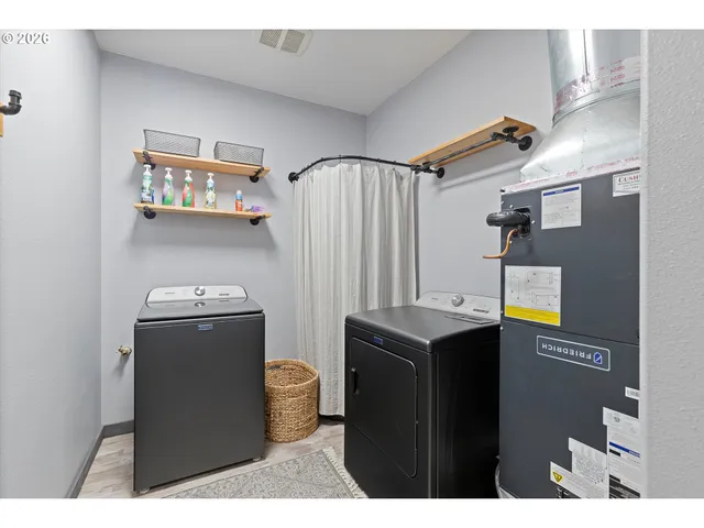 a room with refrigerator and washer