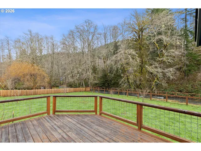 a view of wooden floor and a yard with wooden fence