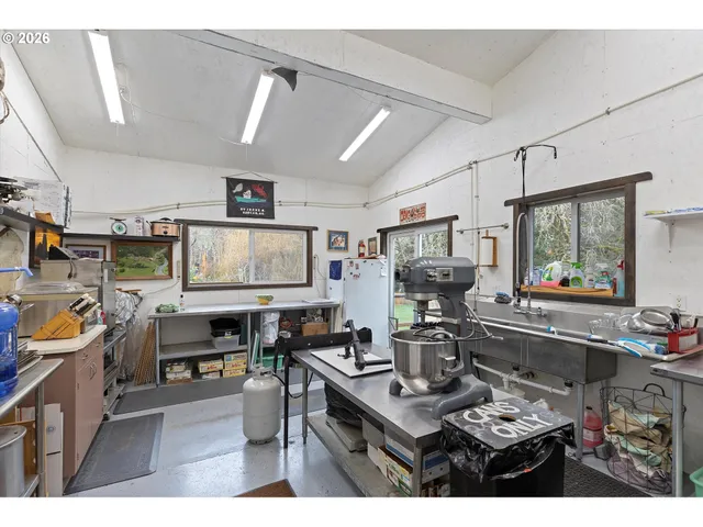 a kitchen with a sink appliances and cabinets
